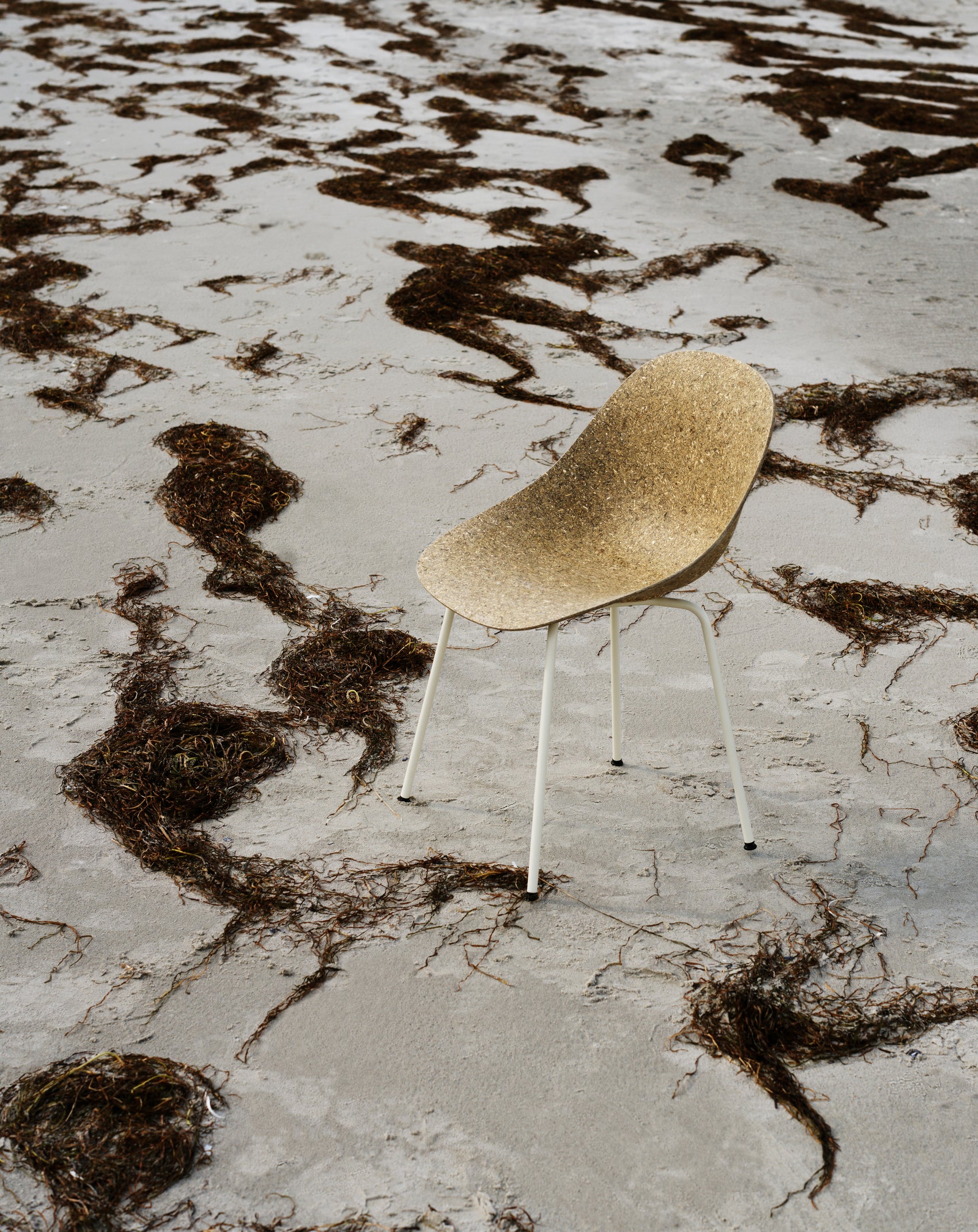A beige mat chair with a black base