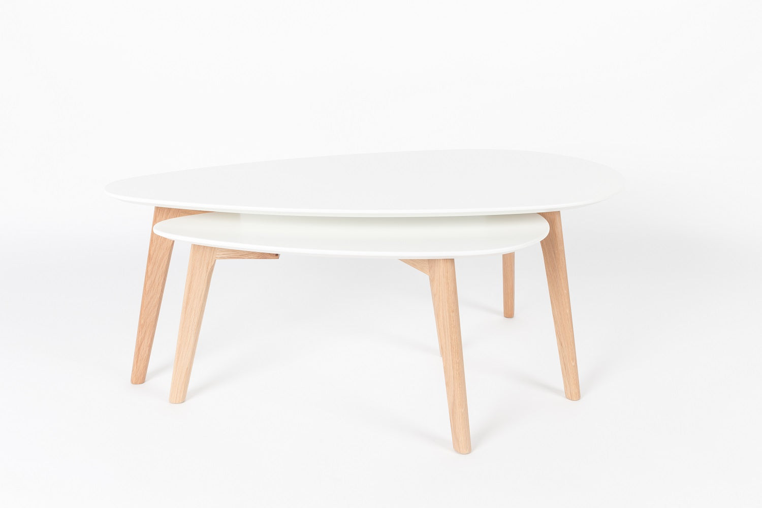A set of white drop tables with a wooden base