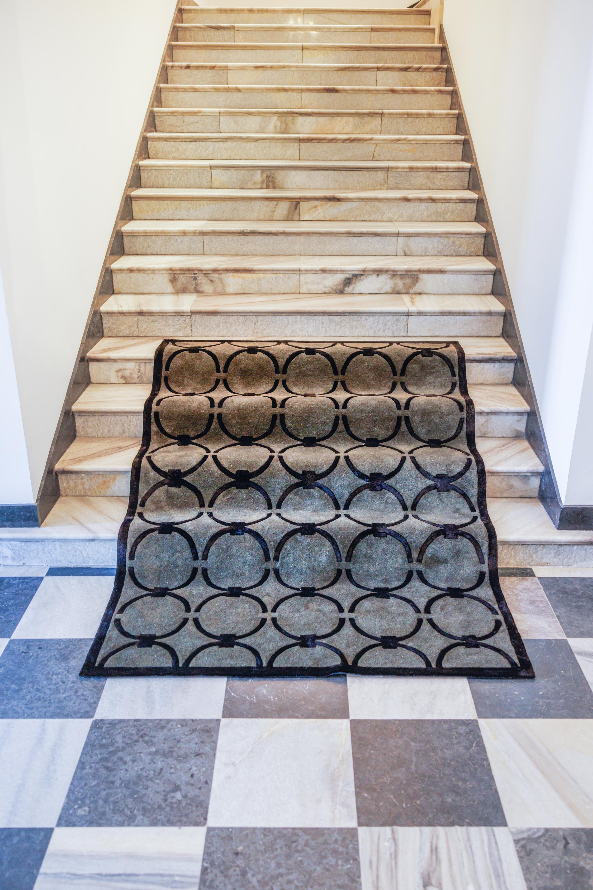 GLAM dark green rug with black geometric pattern