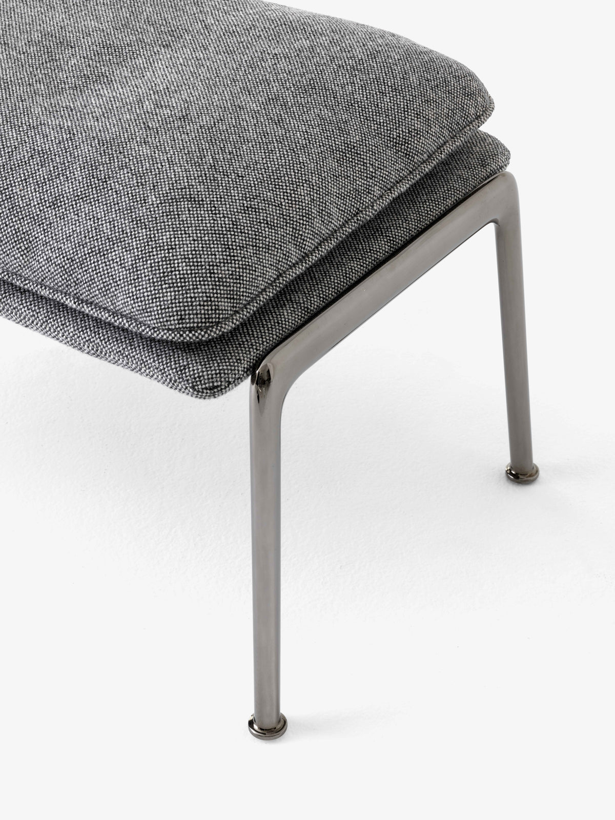 Upholstered MUNO LN20 footstool with a dark aluminum base