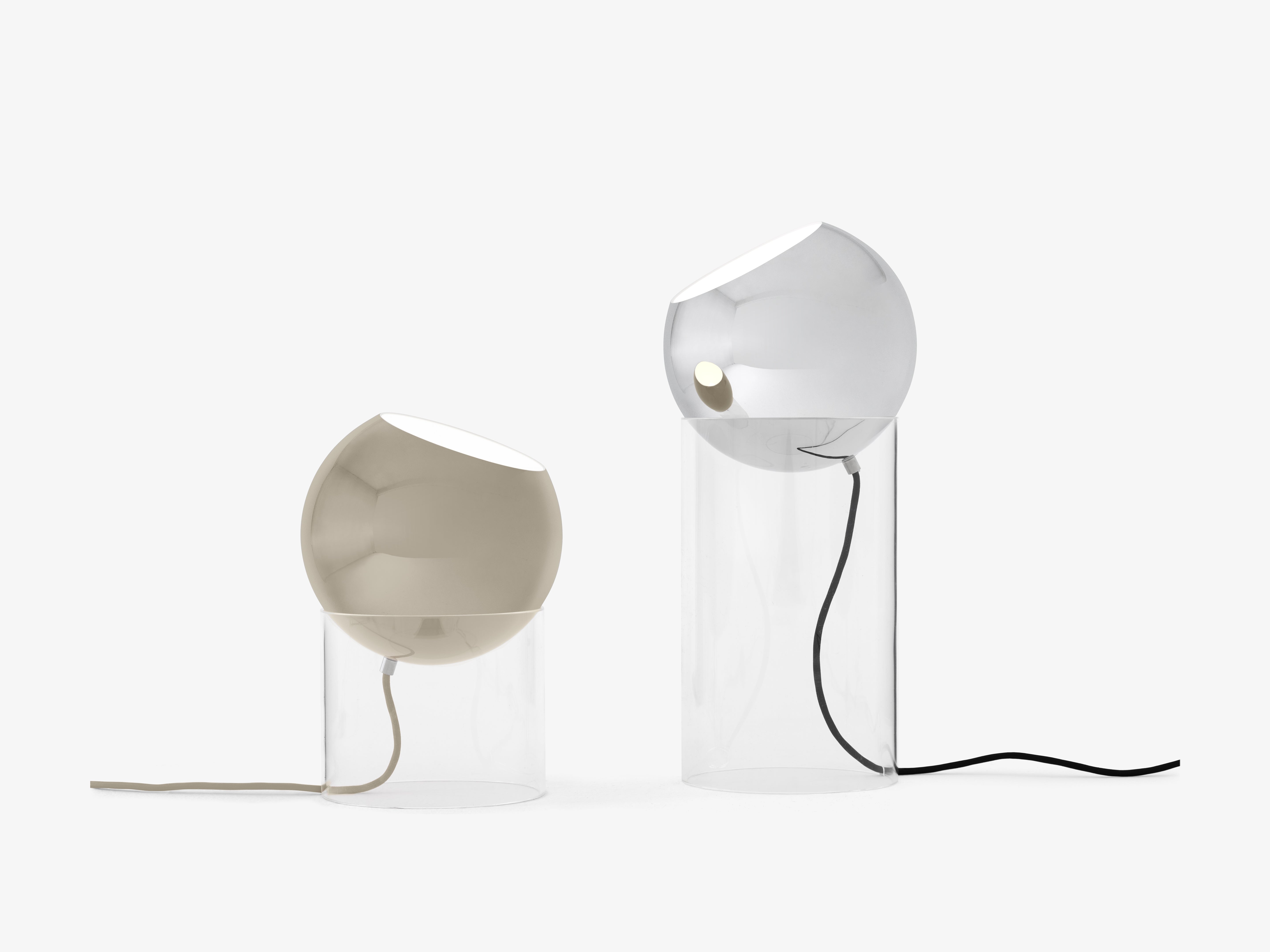 TOPAN table lamp with a gray-beige shade and a transparent base.