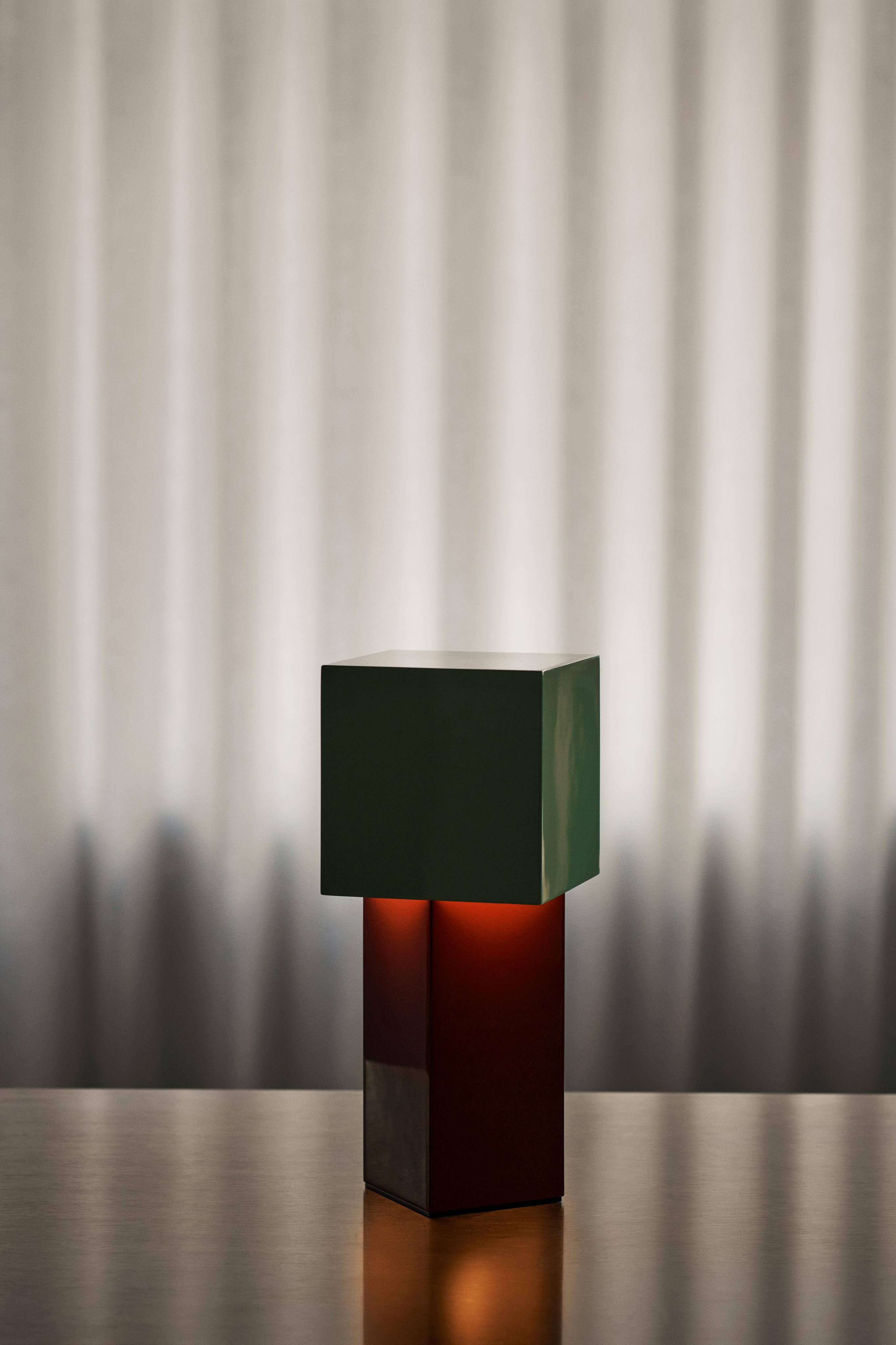 Portable lamp PIVOT ATD7 with a mint shade and a brick base.