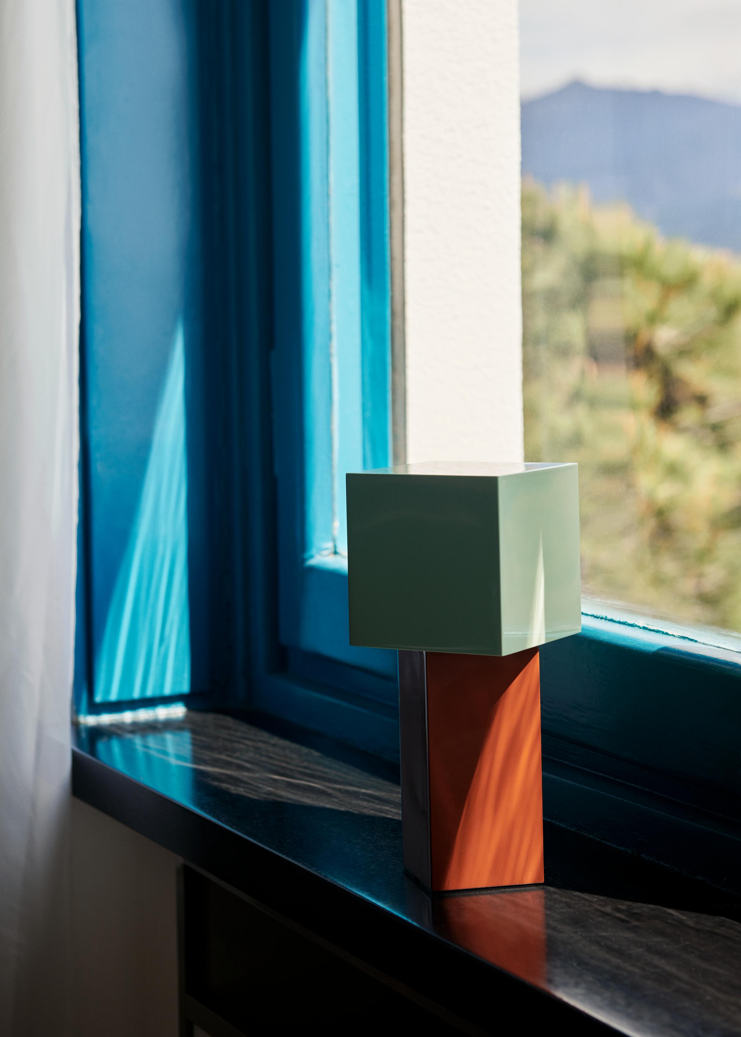 Portable lamp PIVOT ATD7 with a mint shade and a brick base.