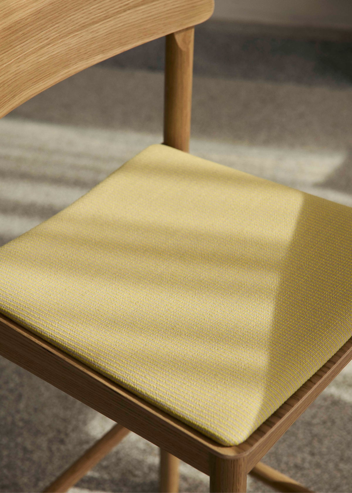 BETTY stool in black lacquered ash with an upholstered seat