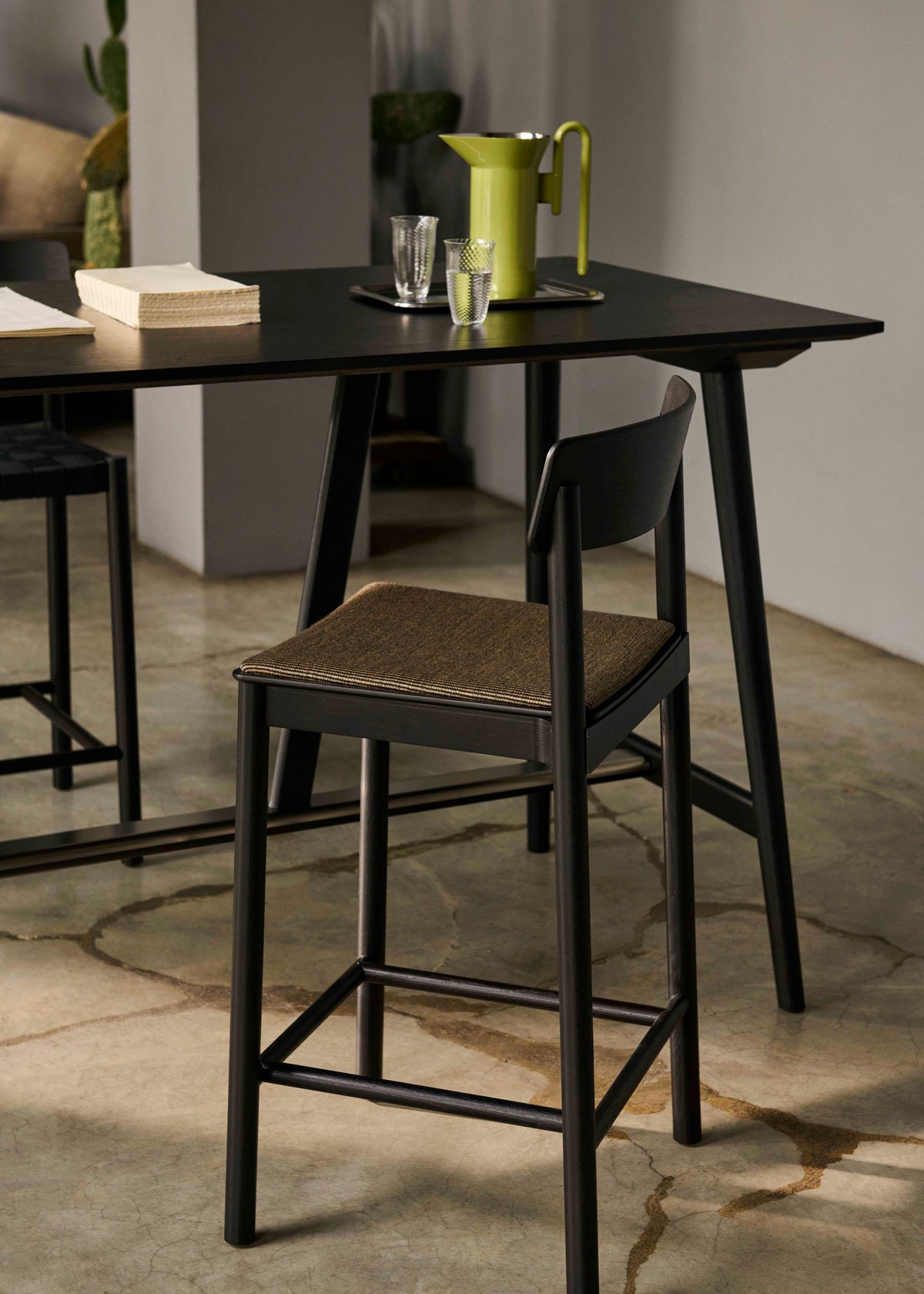 BETTY stool in black lacquered ash with an upholstered seat
