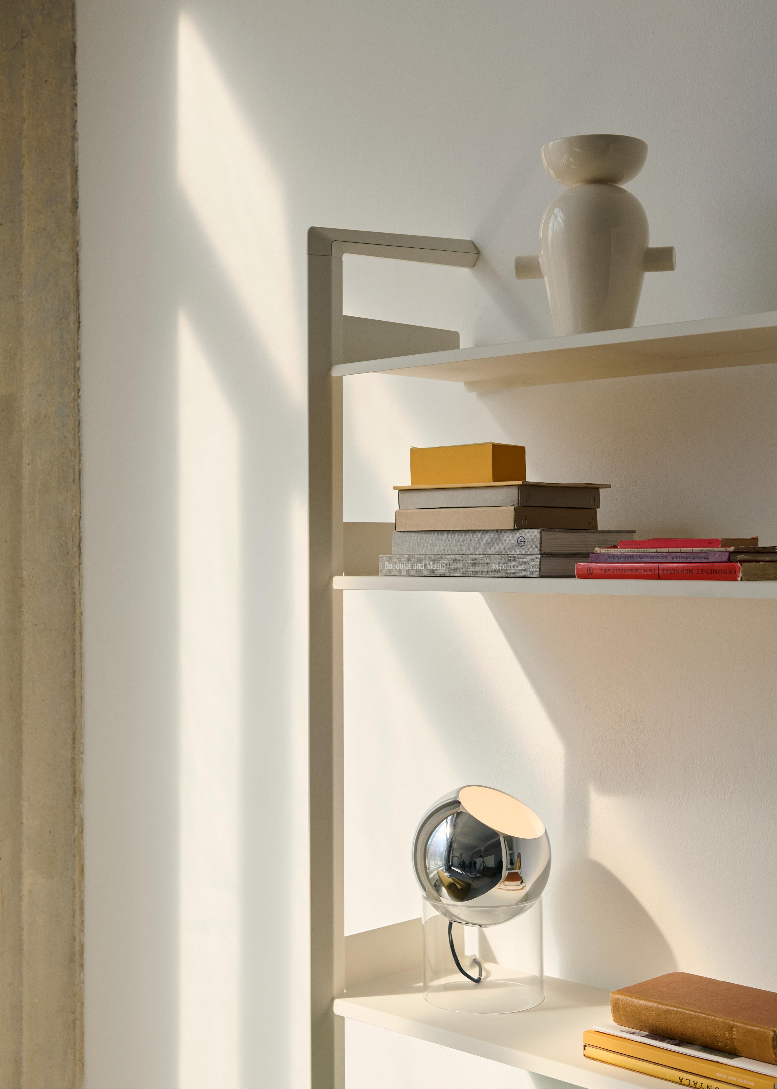 TOPAN VP13 table lamp with a chrome shade and transparent base.