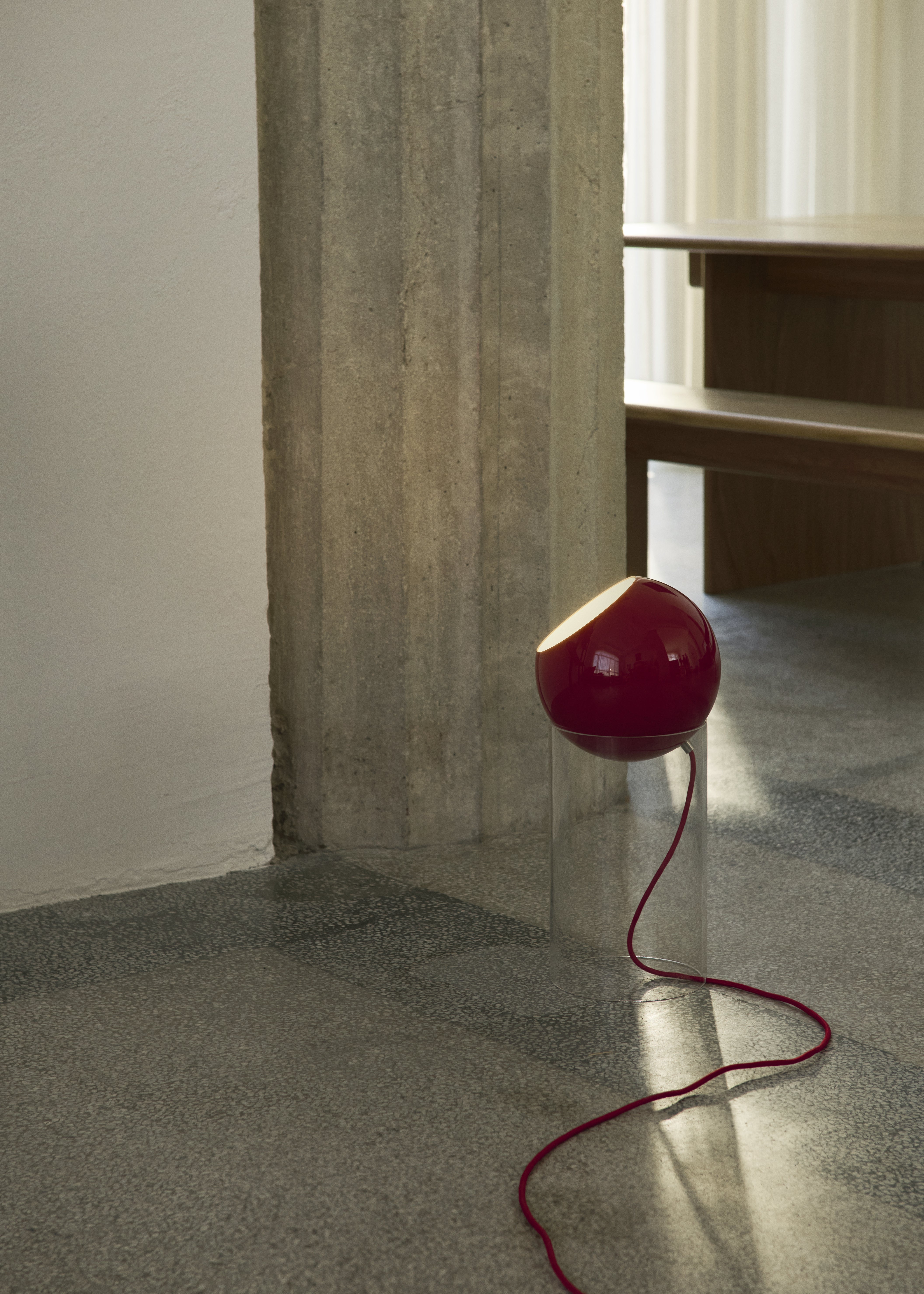 TOPAN table lamp with a red shade and transparent base.