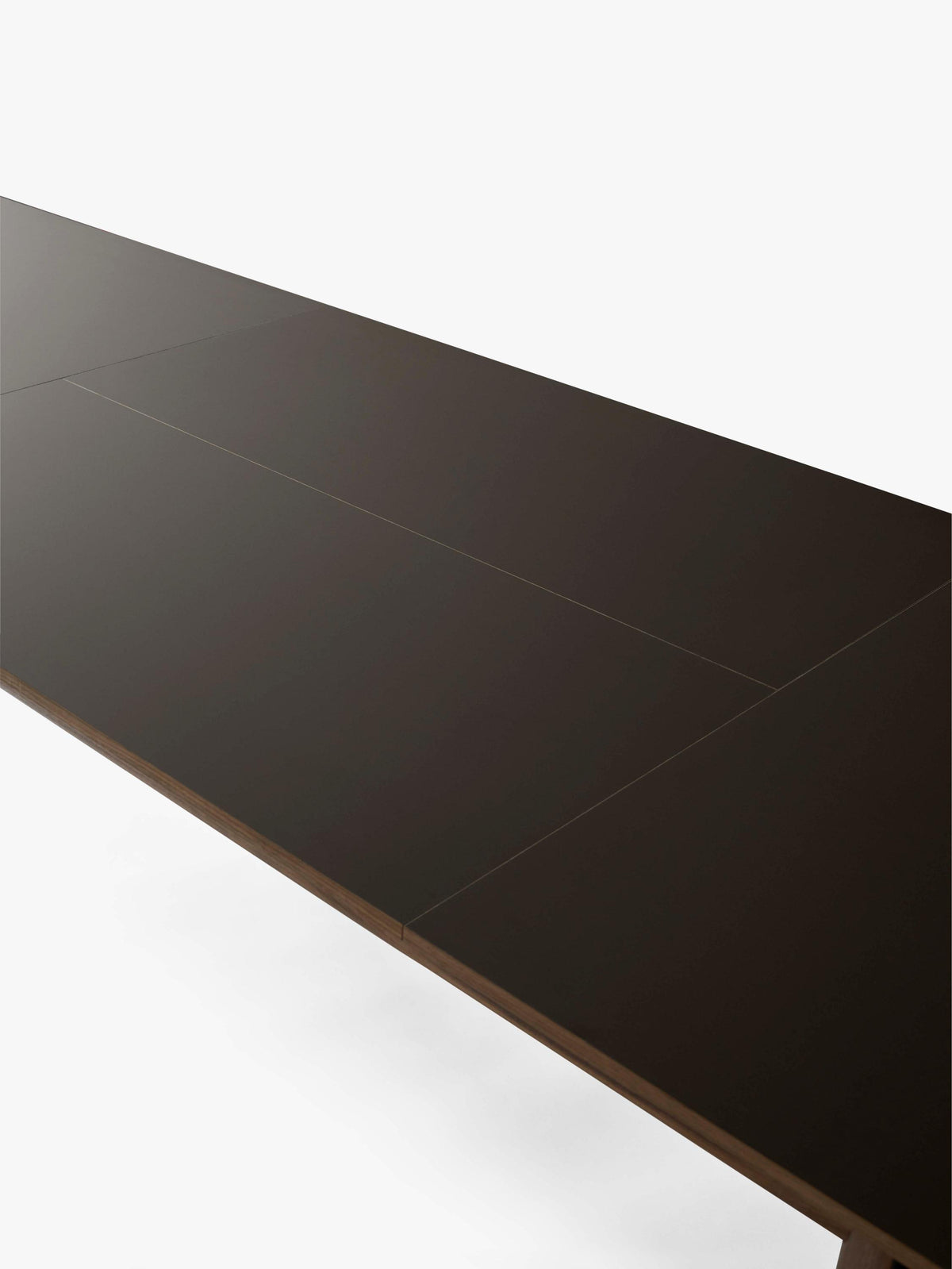 PATCH extendable table with a brown laminated top and walnut base