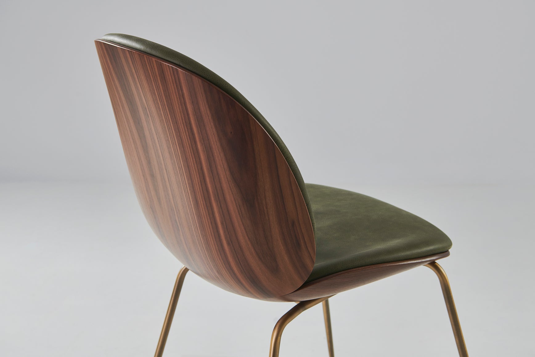 BEETLE upholstered chair with walnut wood and brass base