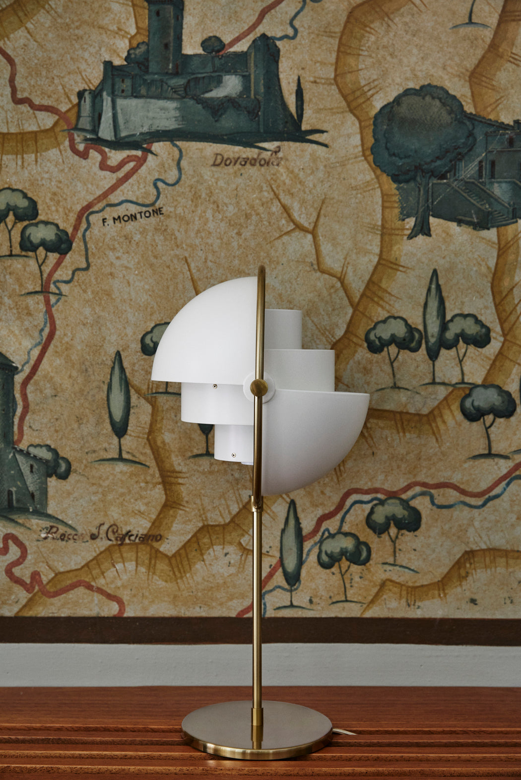 MULTI-LITE table lamp with a brass base and white shade