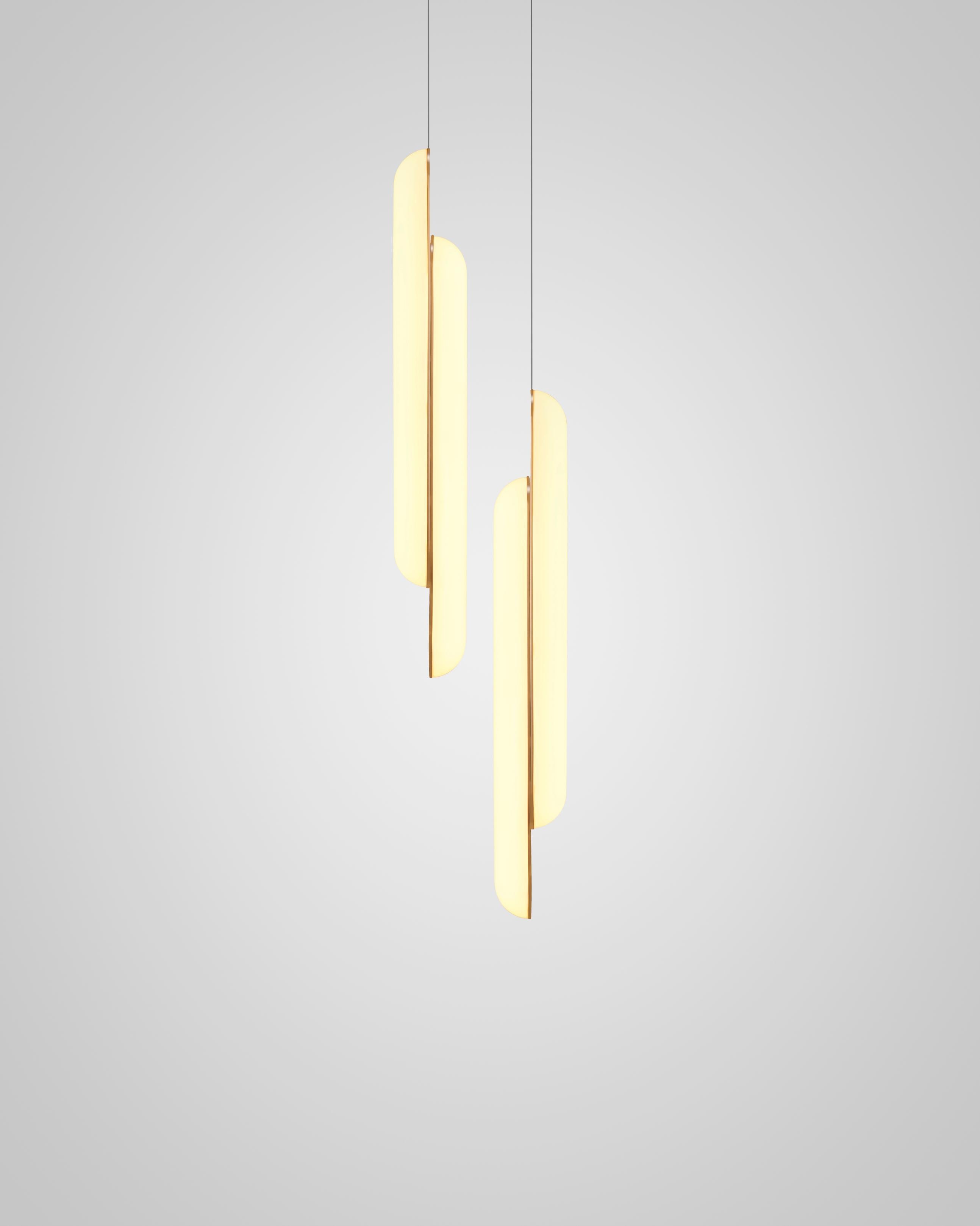 Vertical pendant lamp GEMINI with an opal shade and brass accents.