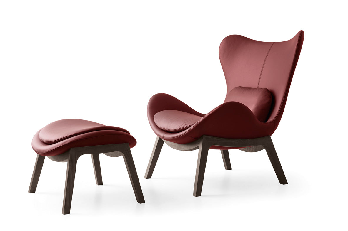 Upholstered LAZY armchair with a dark wooden base
