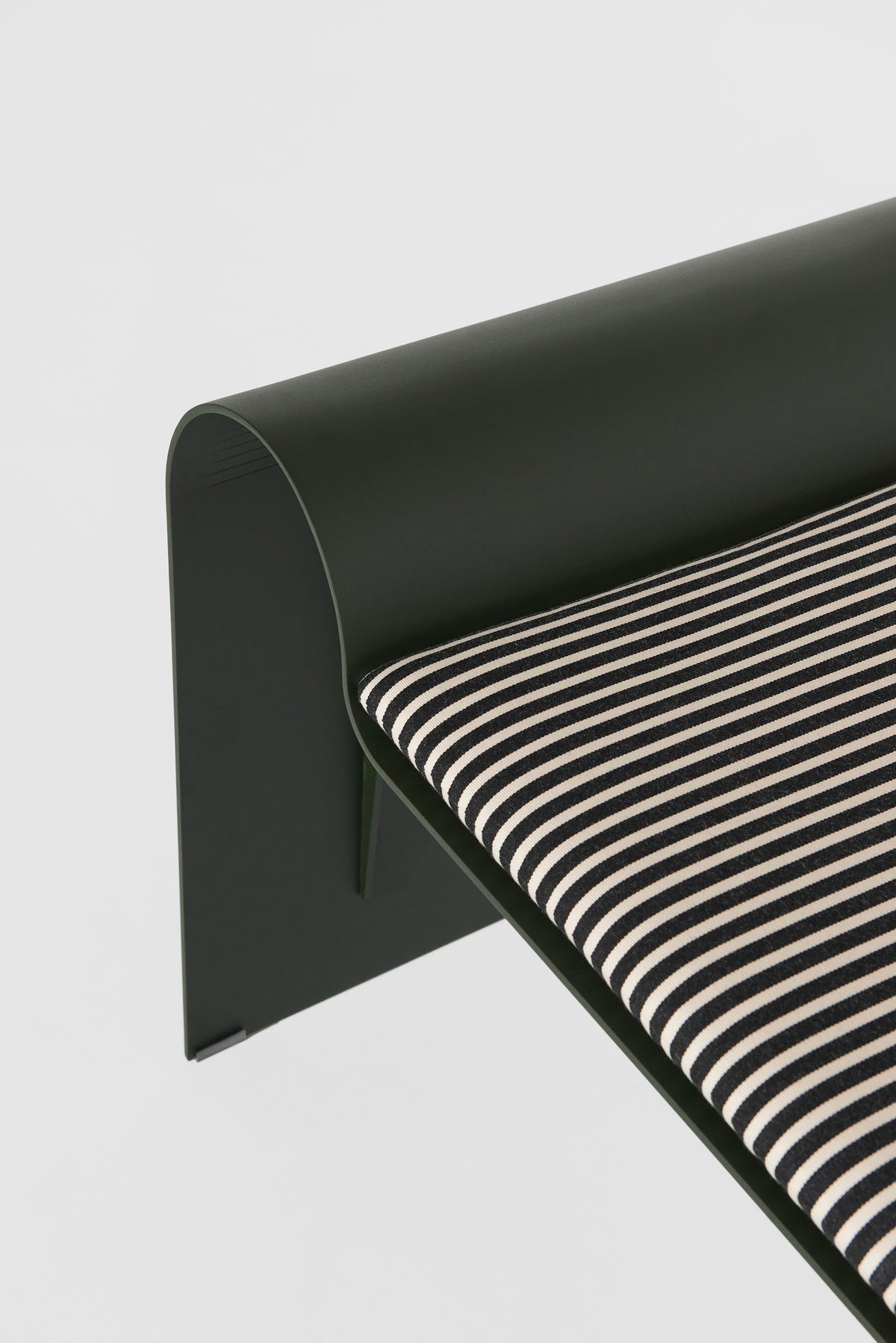 ECLIPSE bench in dark green with a striped cushion