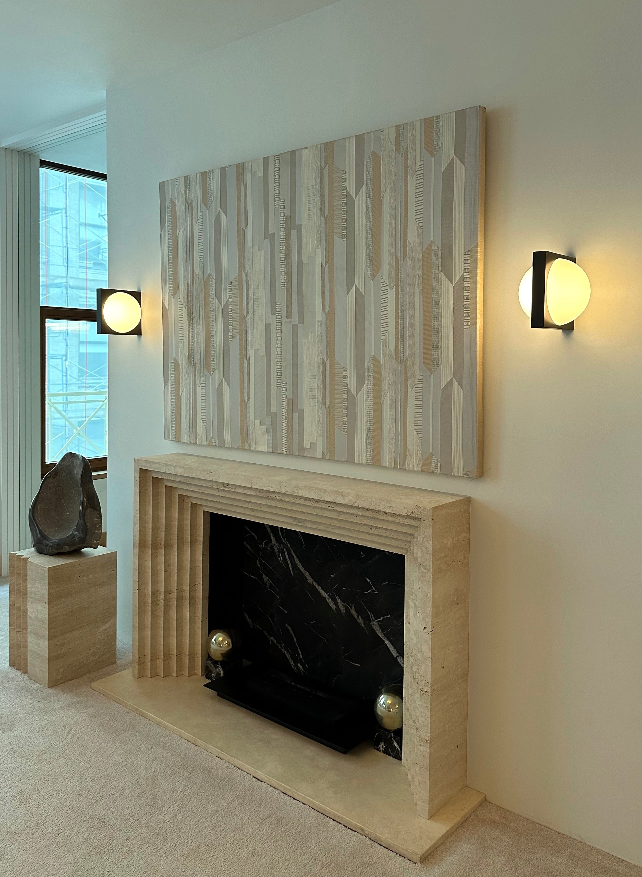 SOLSTICE wall lamp with an opal shade and blackened brass.