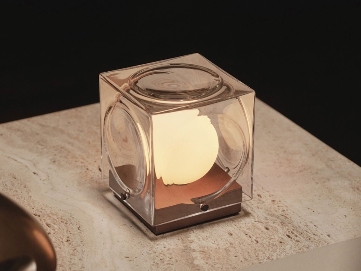 Portable lamp CHANT with a glass shade and silver base.
