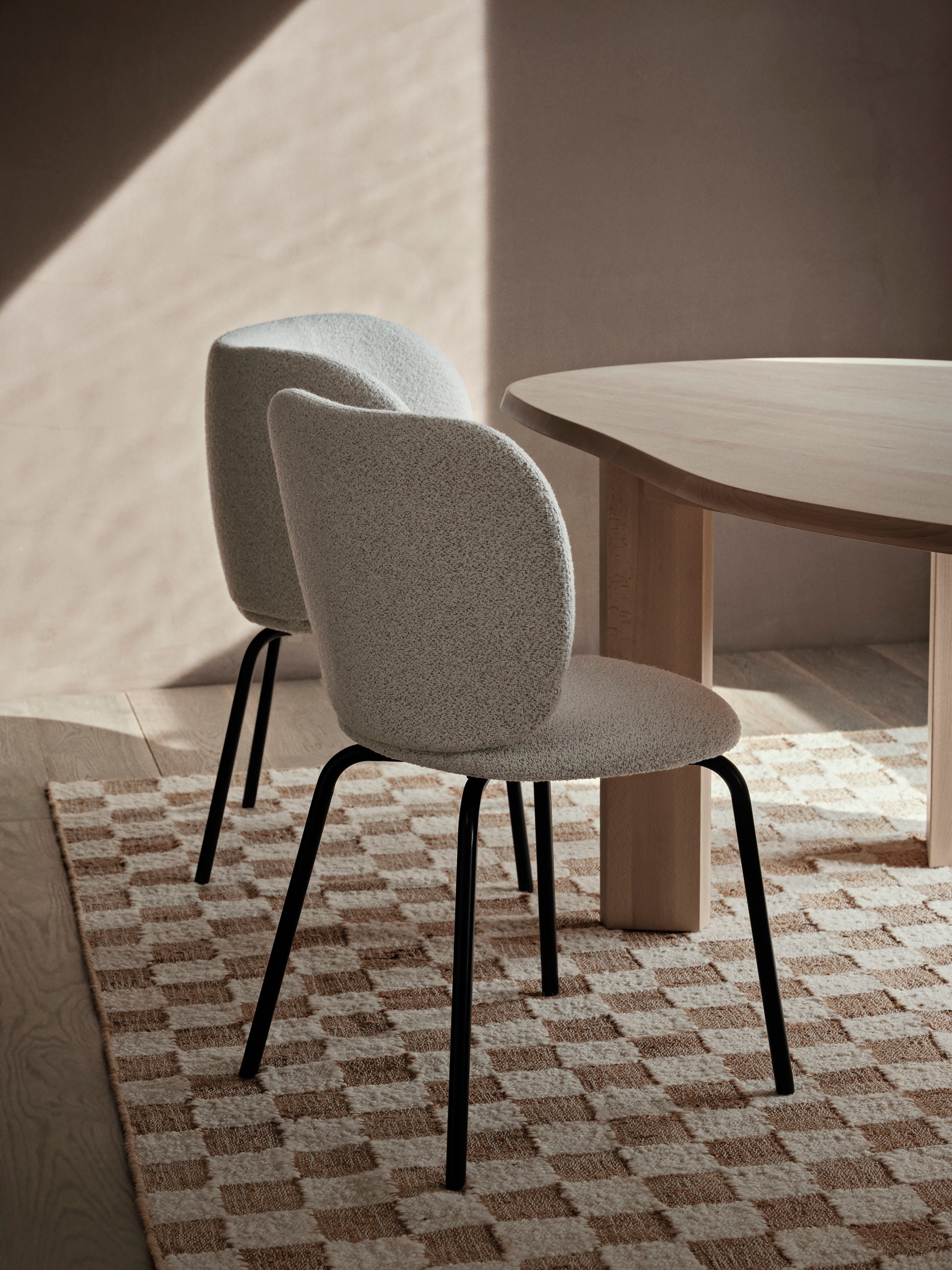Rico Soft Bouclé chair broken white with a black base