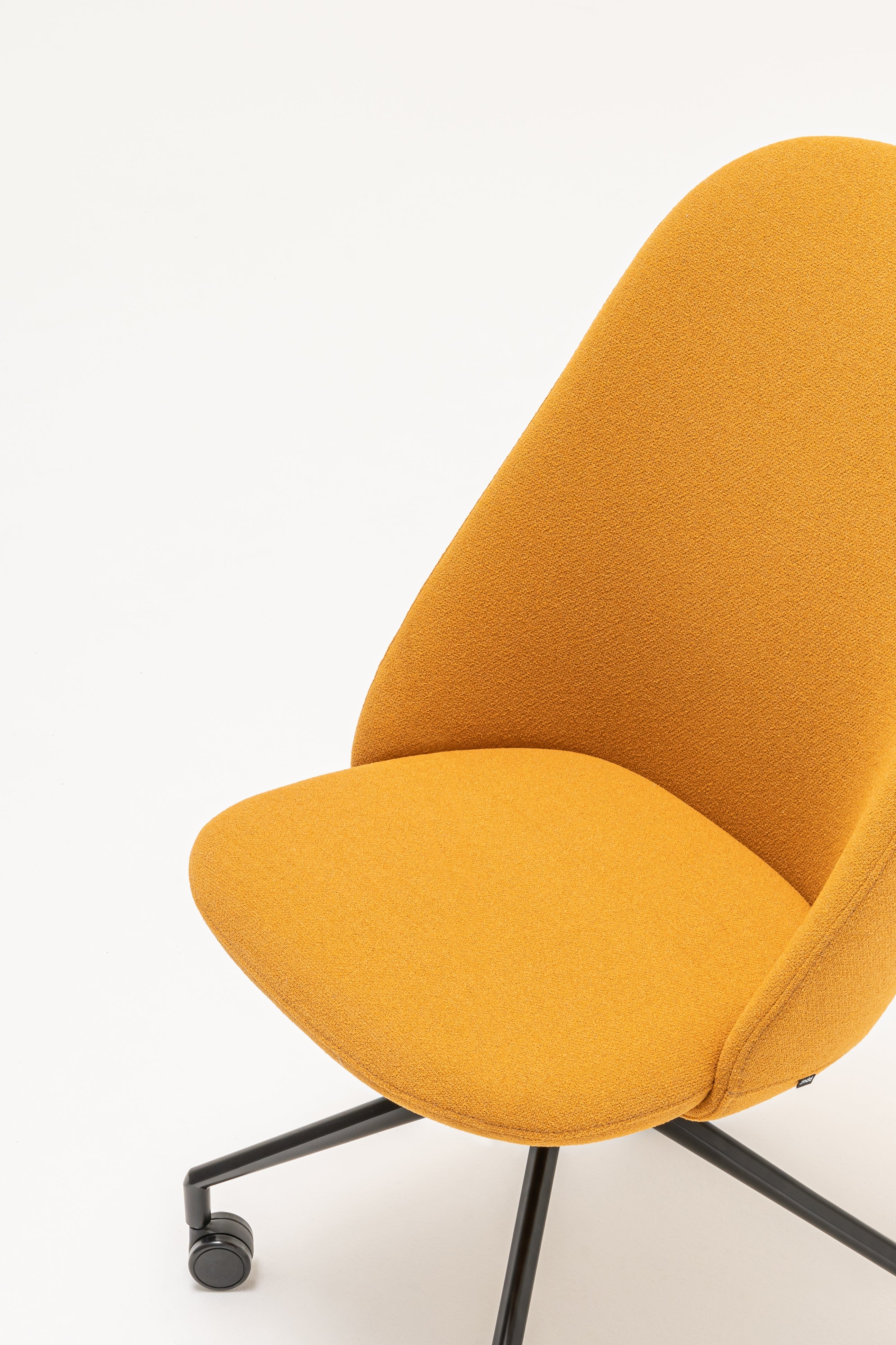 Rotable armchair with a high back parallel metal base with wheels to a hard surface