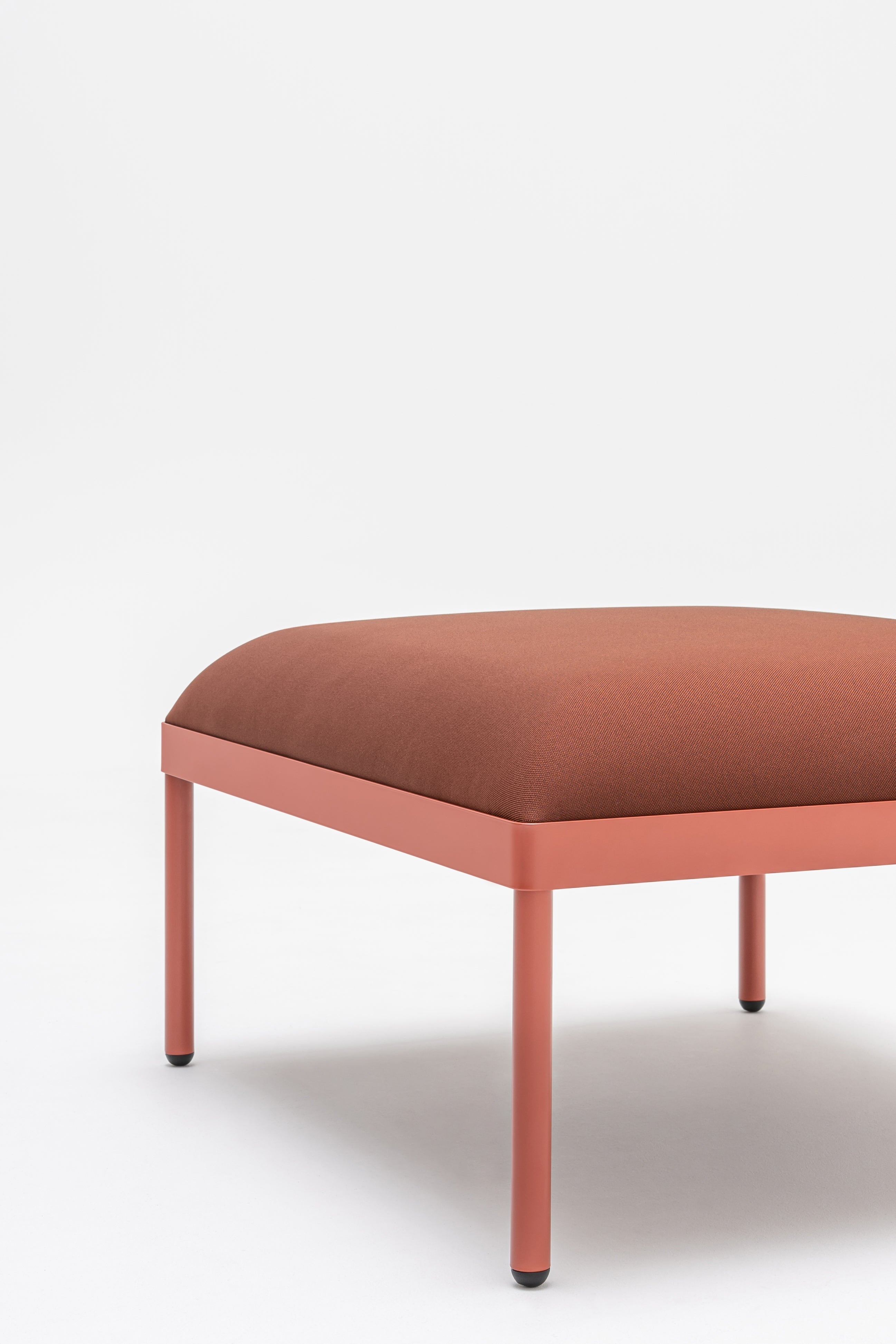 Upholstered stilt pouf
