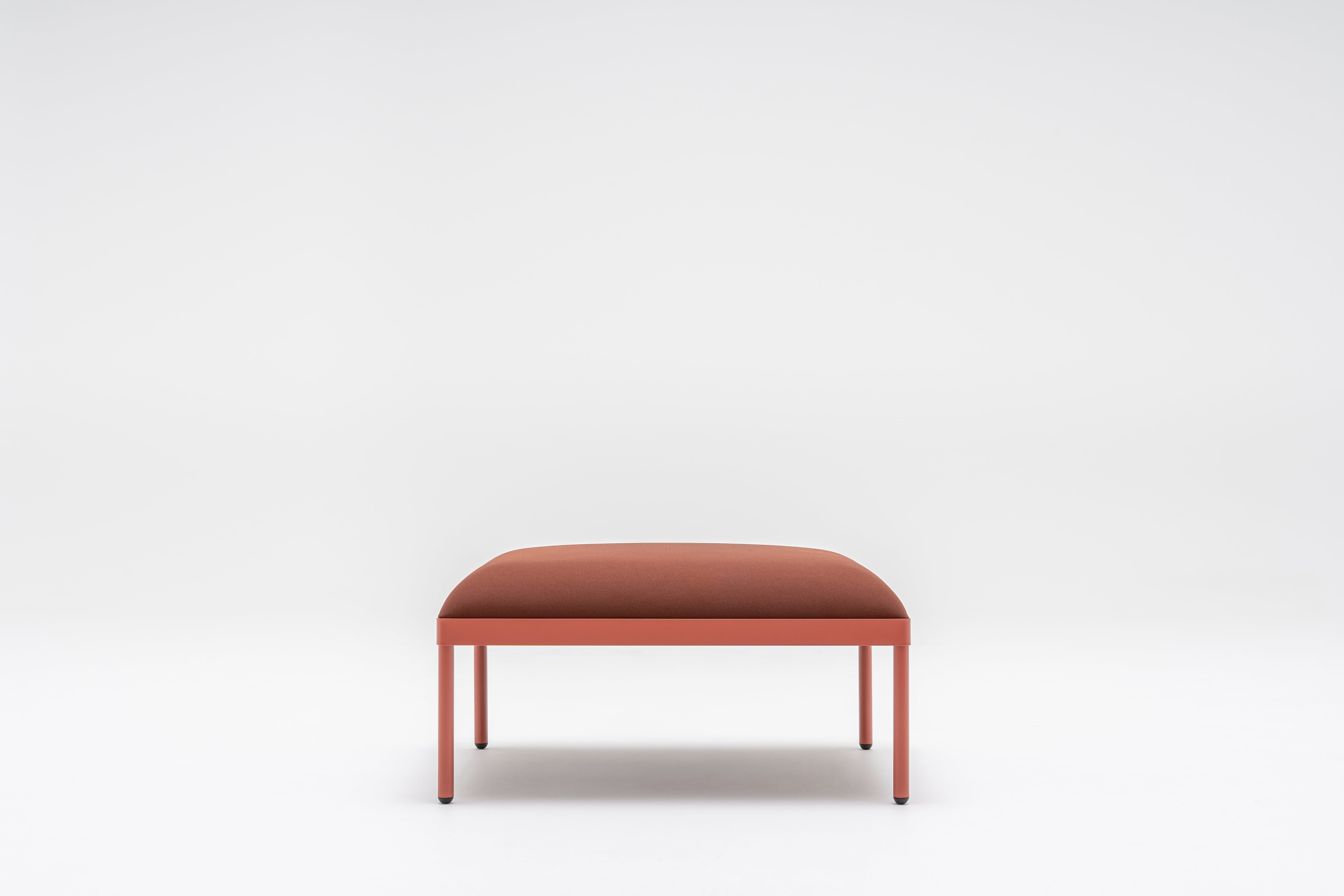 Upholstered stilt pouf