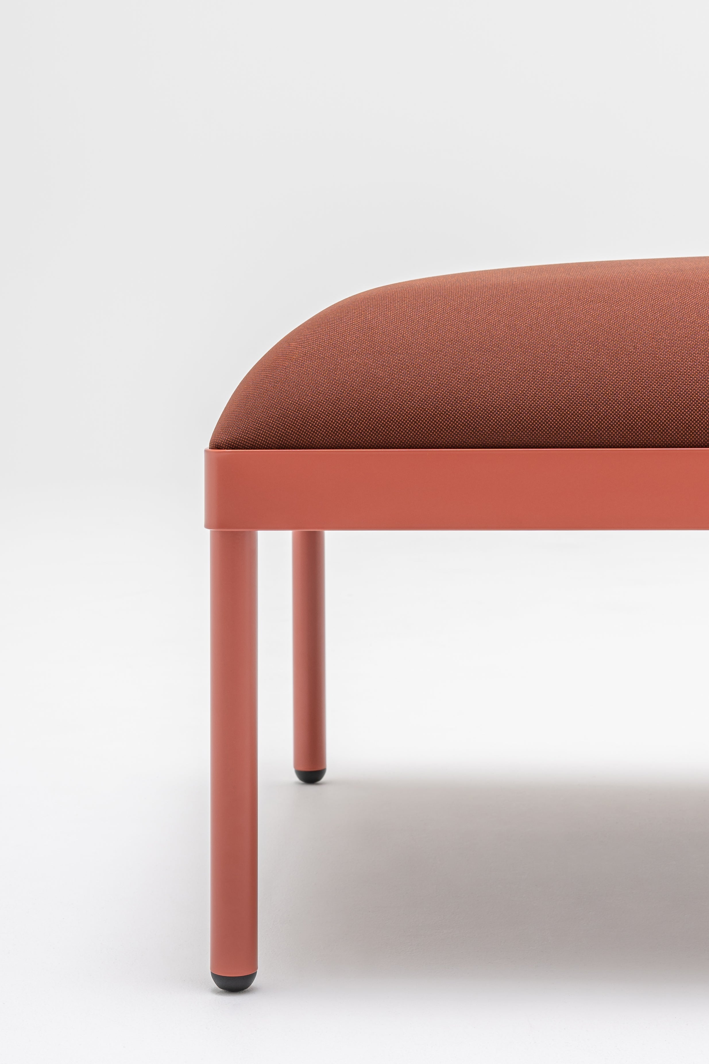 Upholstered stilt pouf