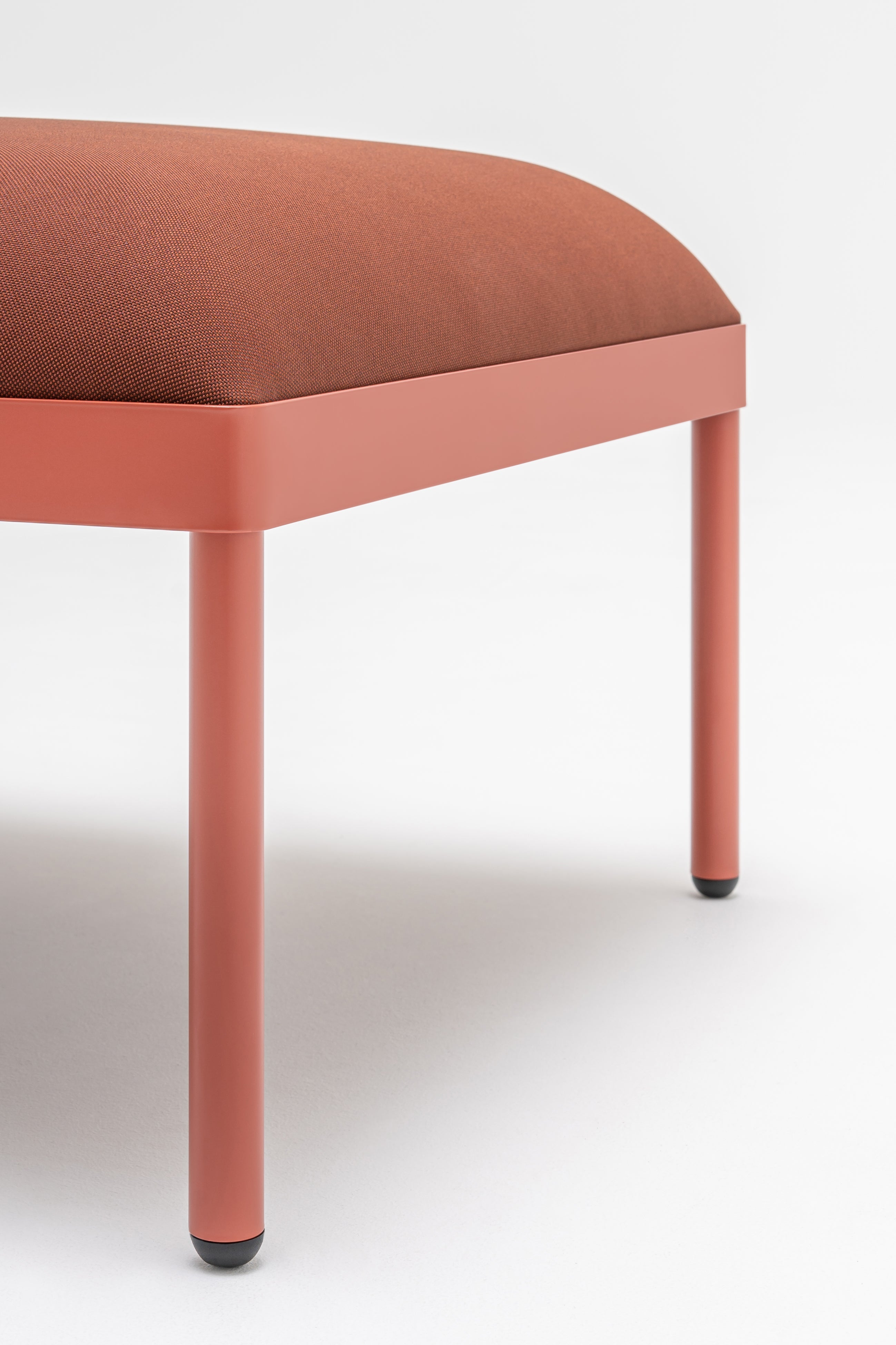Upholstered stilt pouf
