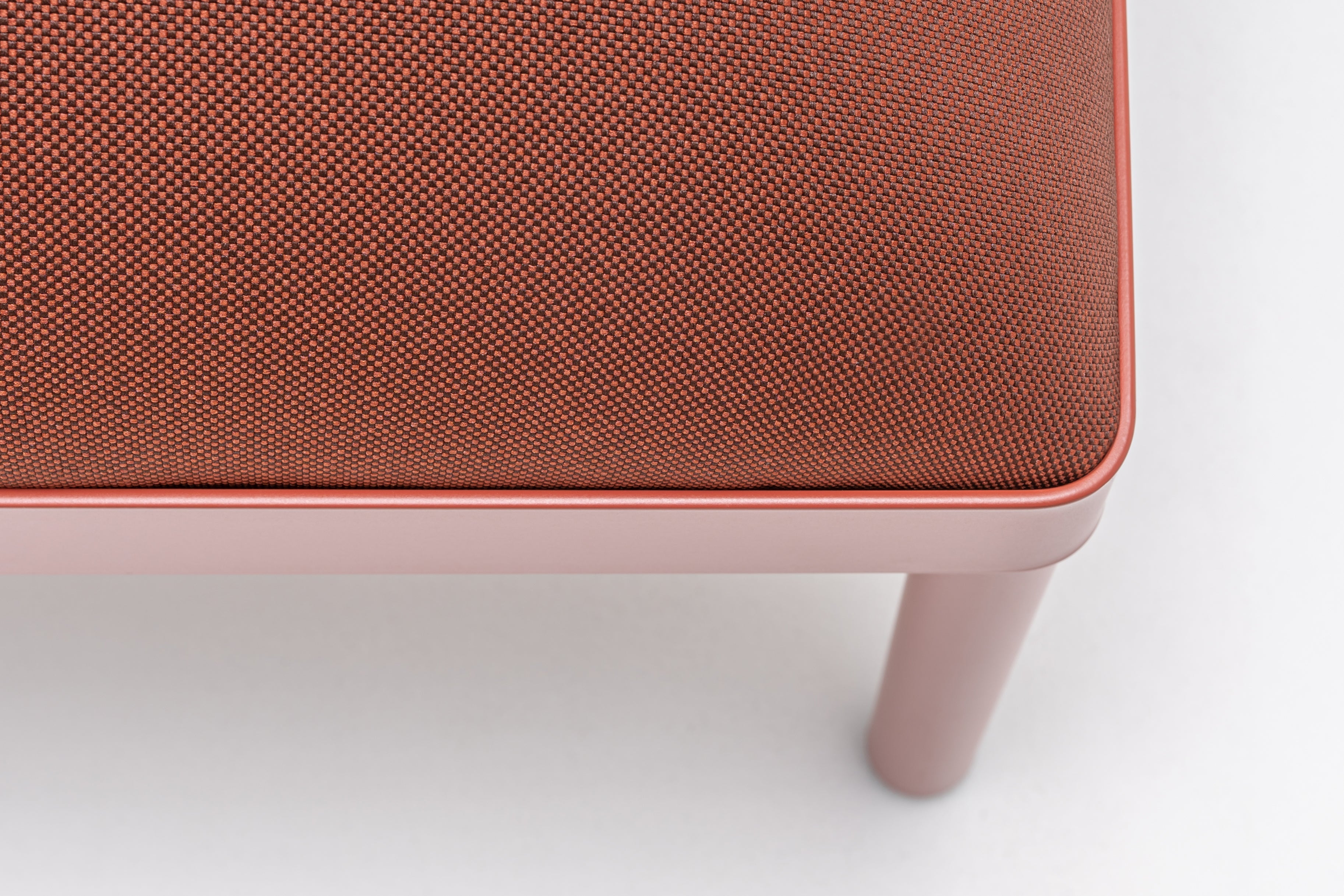 Upholstered stilt pouf