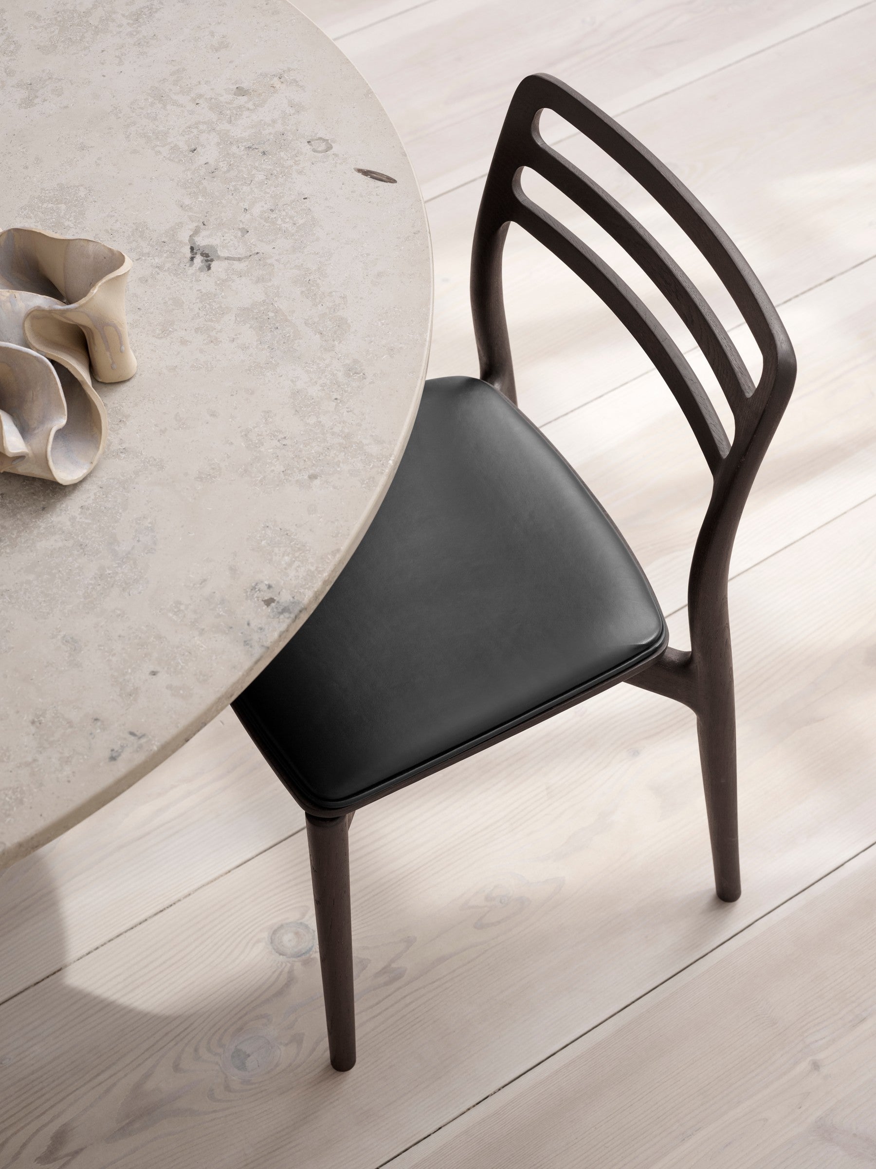 Round Table CABIN with a gray limestone top and a dark oak base