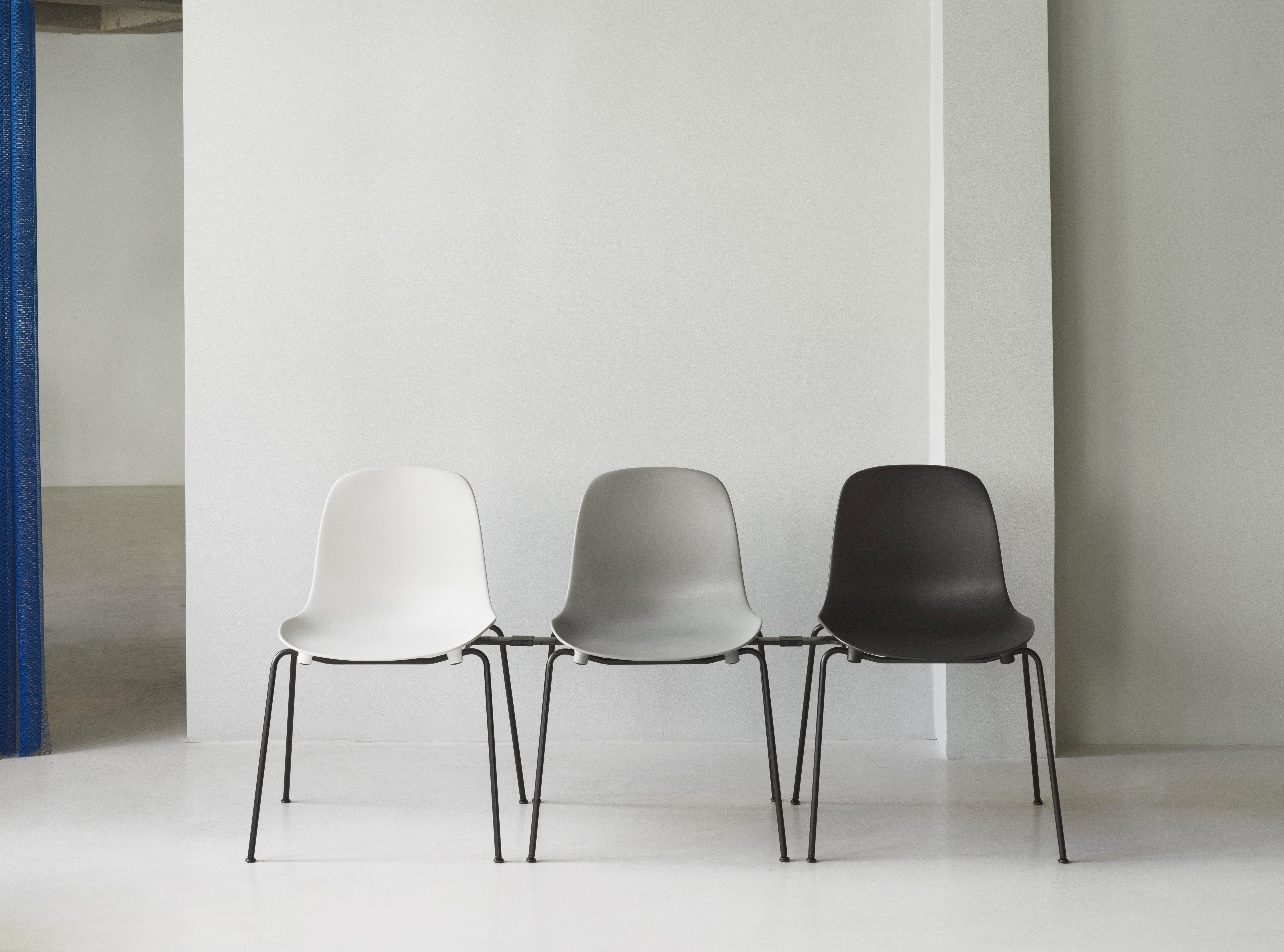 Blue stacking chair with a black base