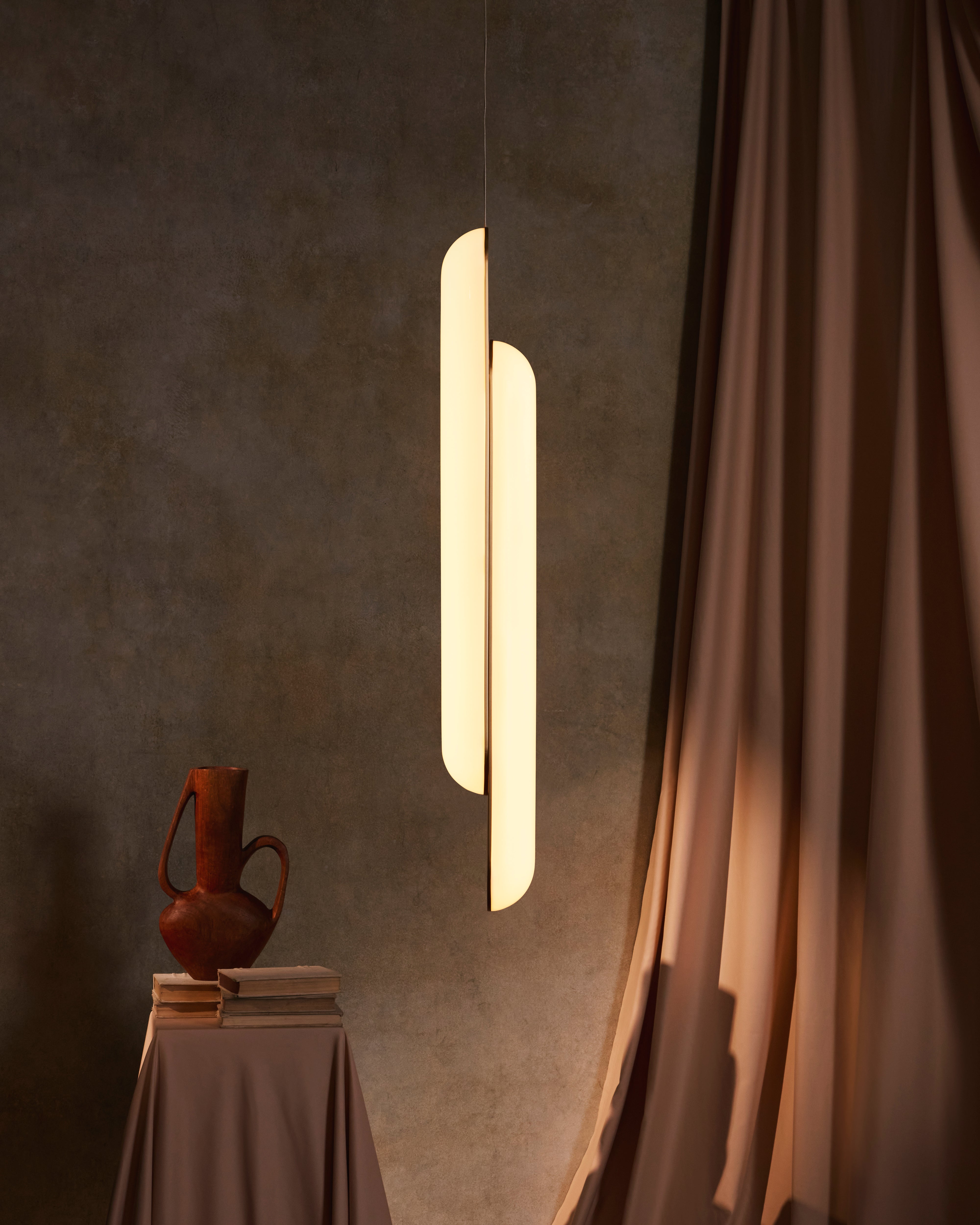 Vertical pendant lamp GEMINI with an opal shade and brass accents.