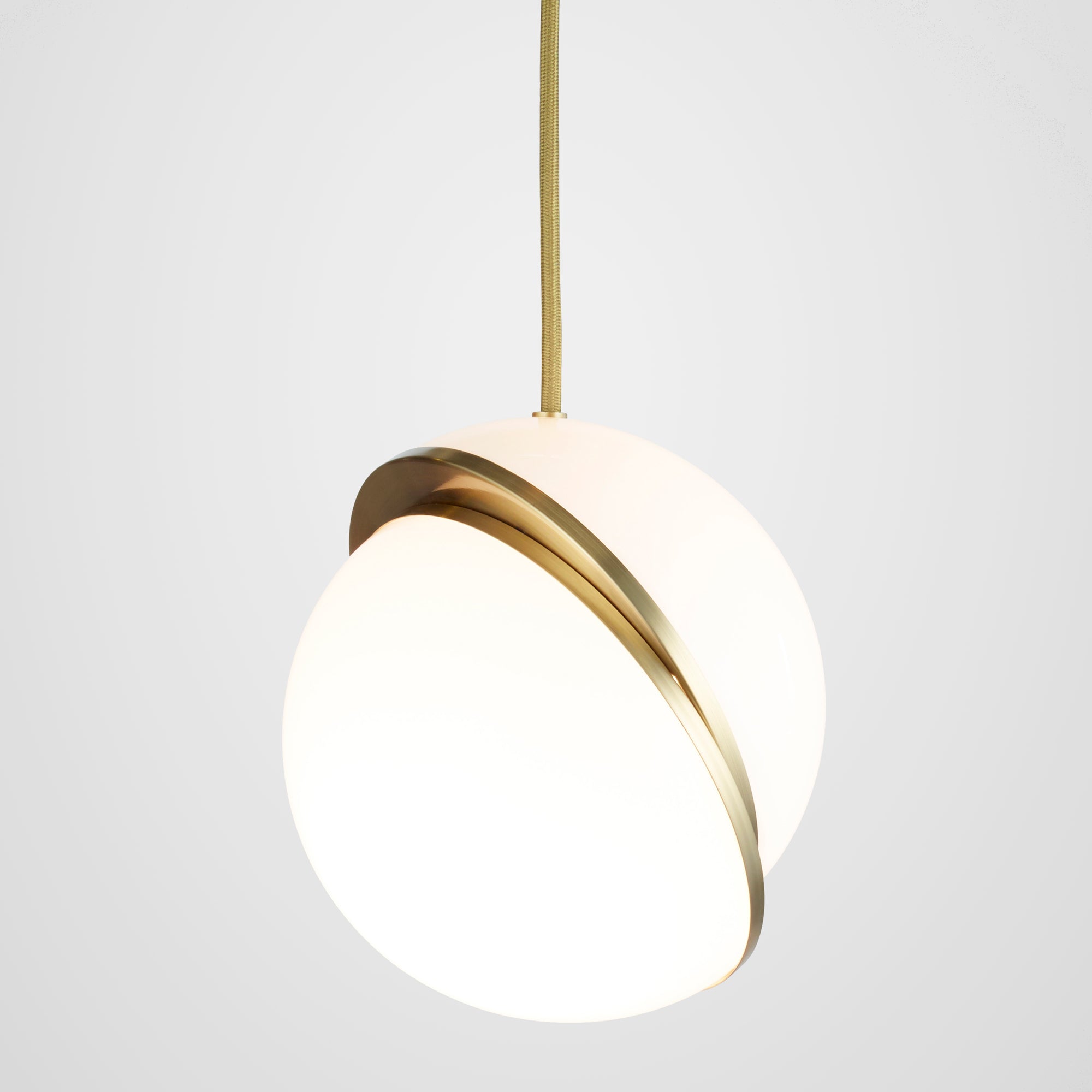 CRESCENT pendant lamp with an opal shade and brass accents.