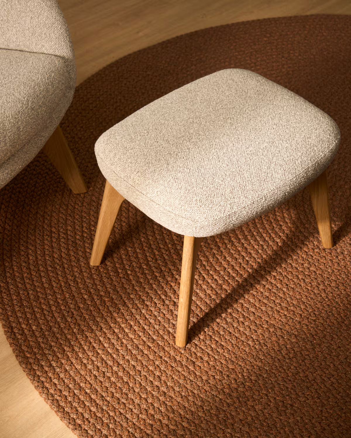 ADIRAN footstool in light beige chenille with a dark oak base.
