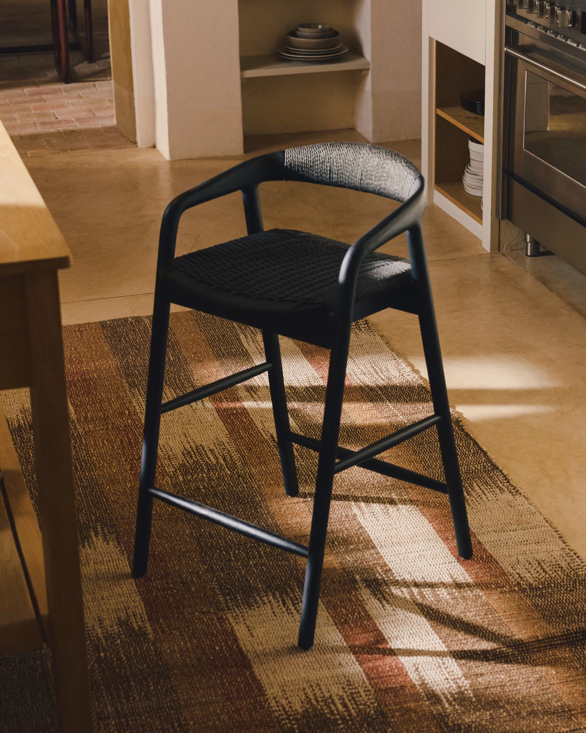 DERILE bar stool in black oak wood with a black cord.