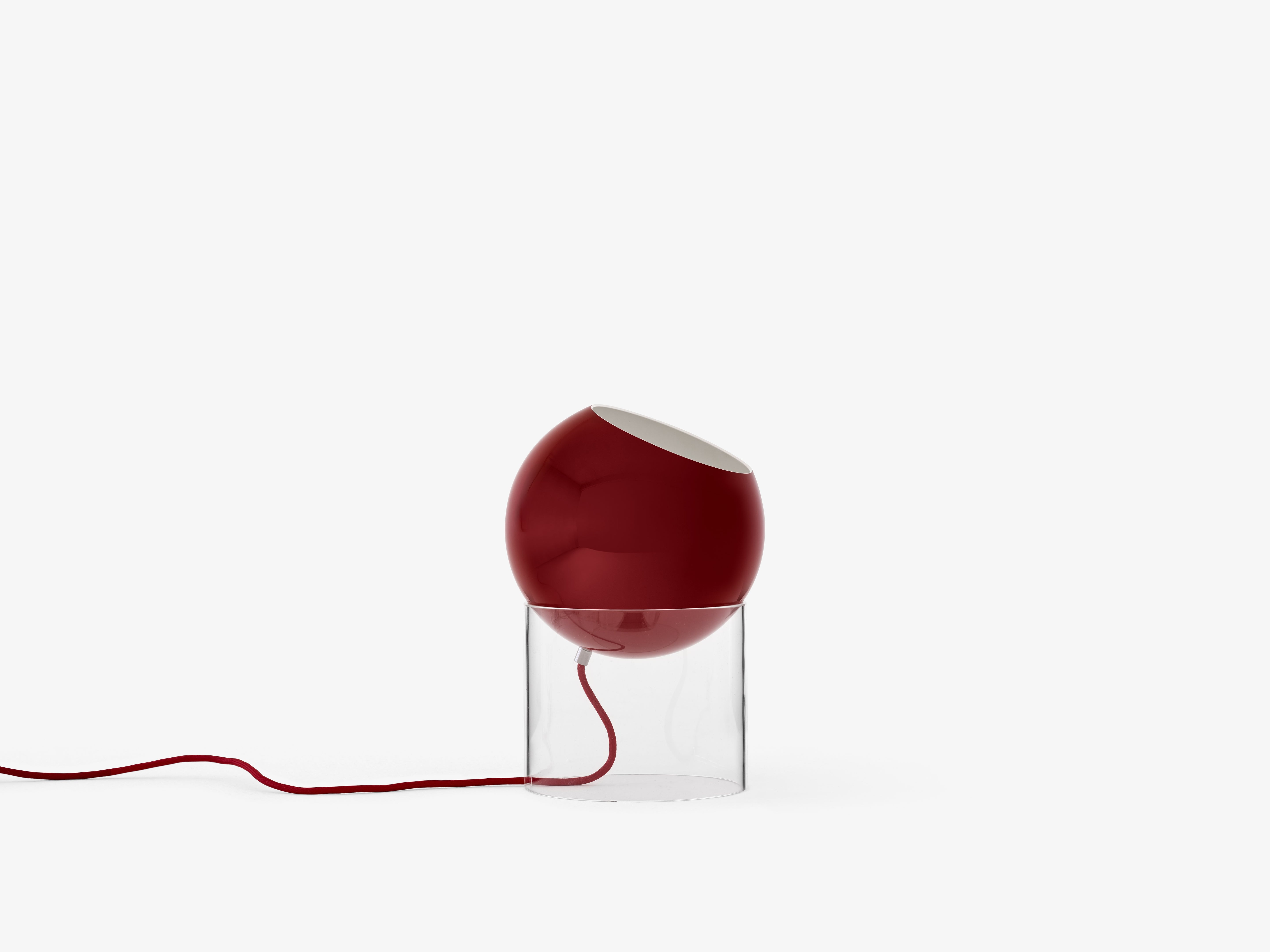 TOPAN table lamp with a red shade and transparent base.