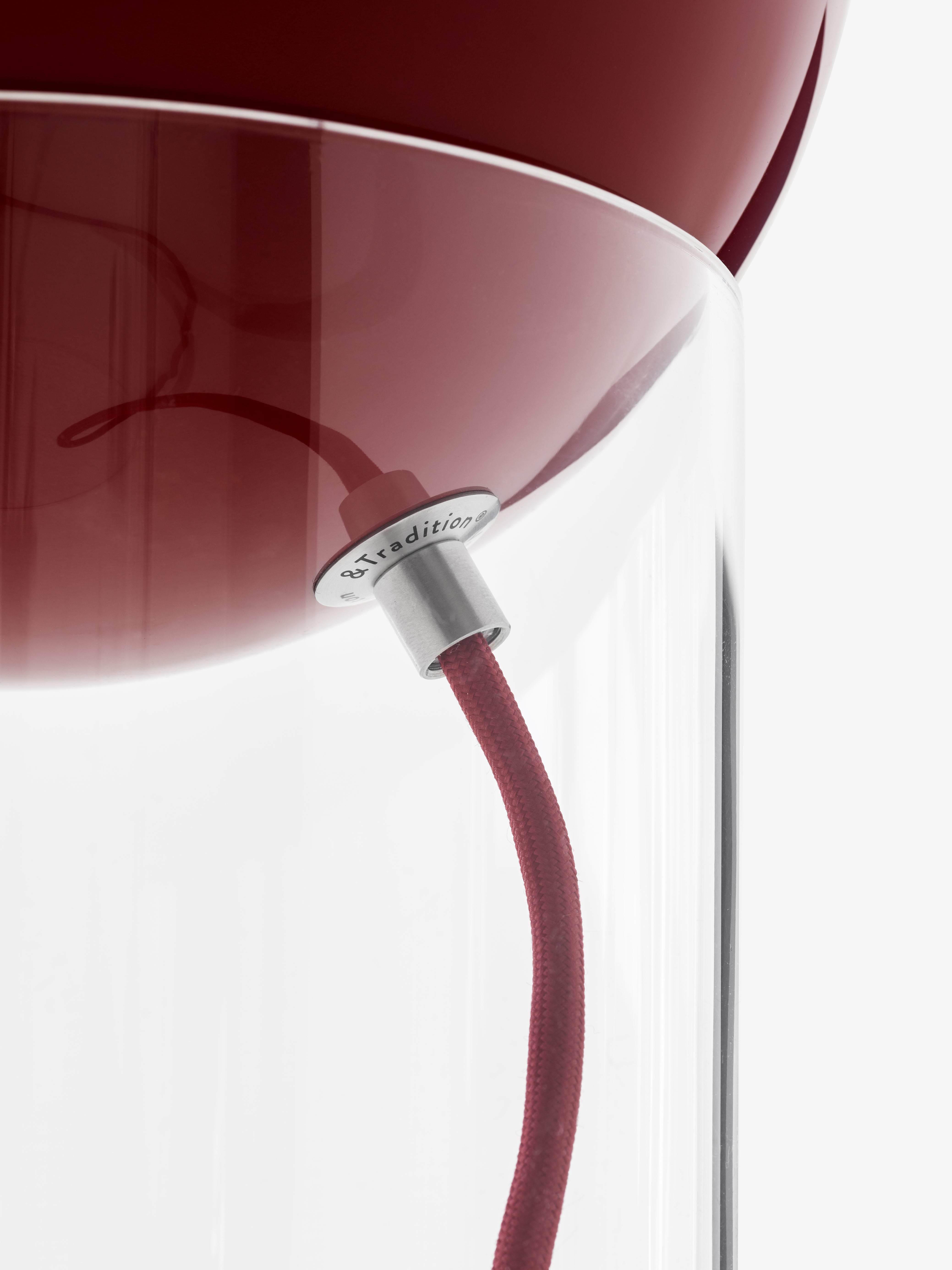 TOPAN table lamp with a red shade and transparent base.