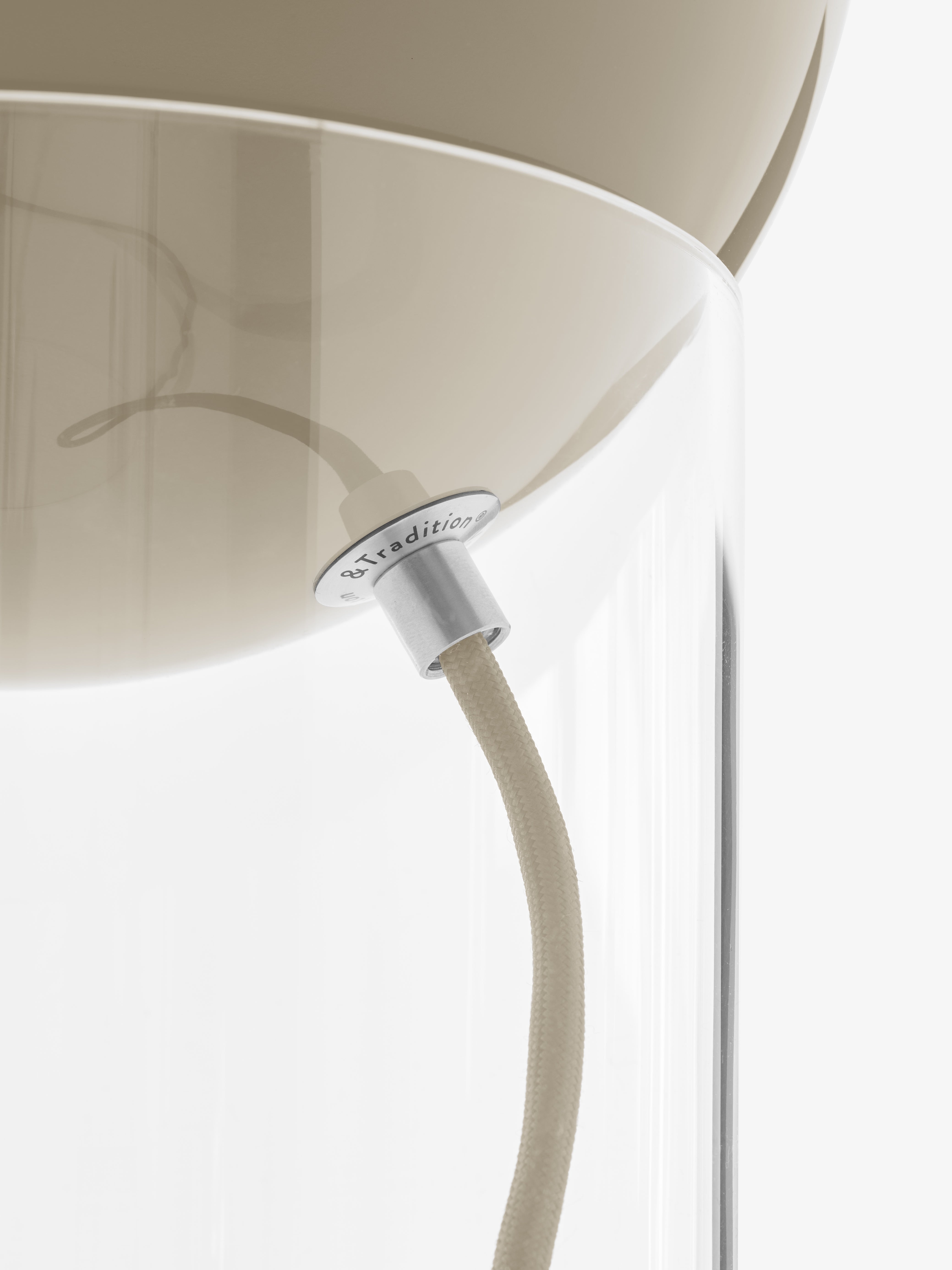 TOPAN table lamp with a gray-beige shade and a transparent base.