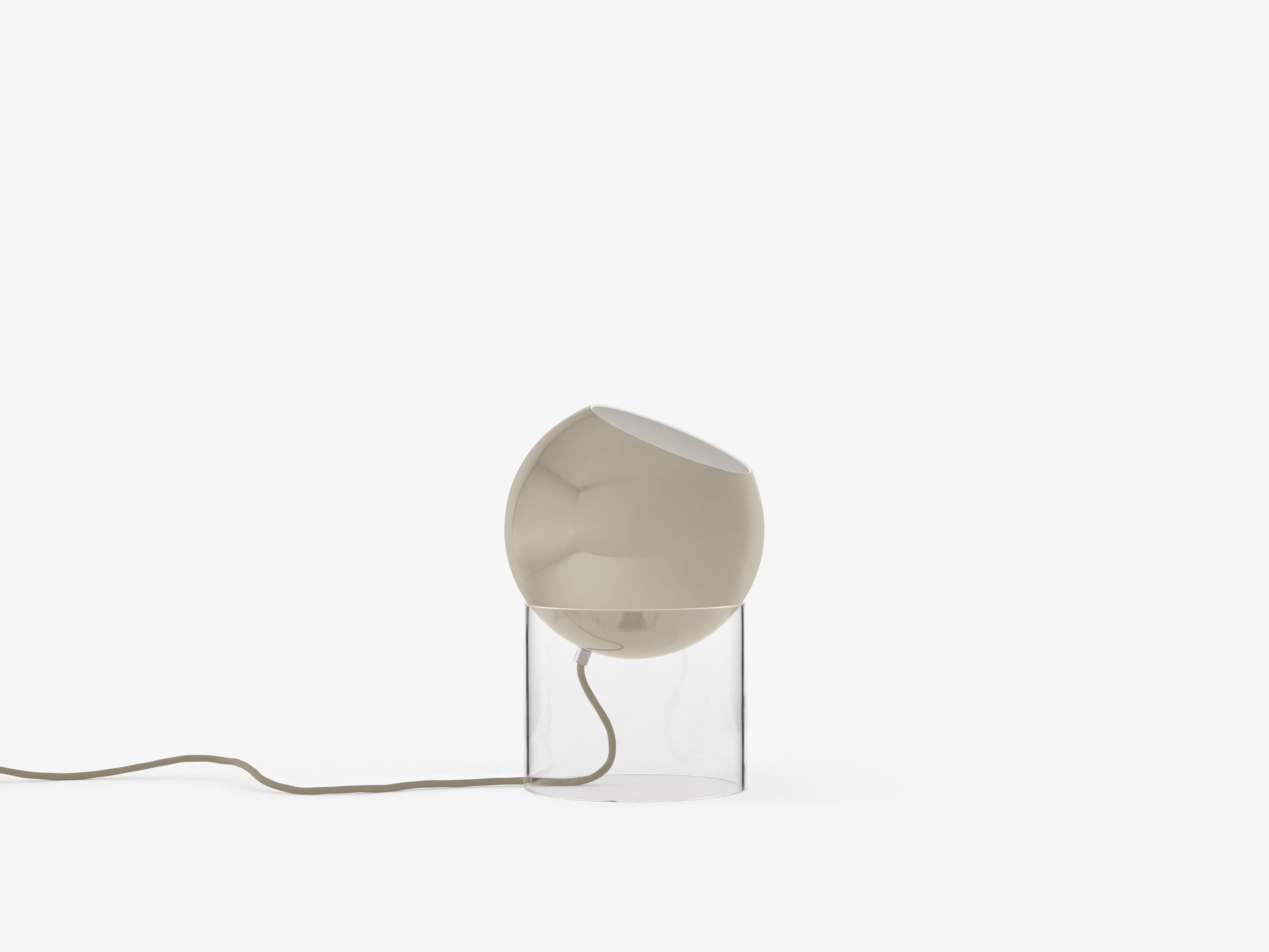 TOPAN table lamp with a gray-beige shade and a transparent base.
