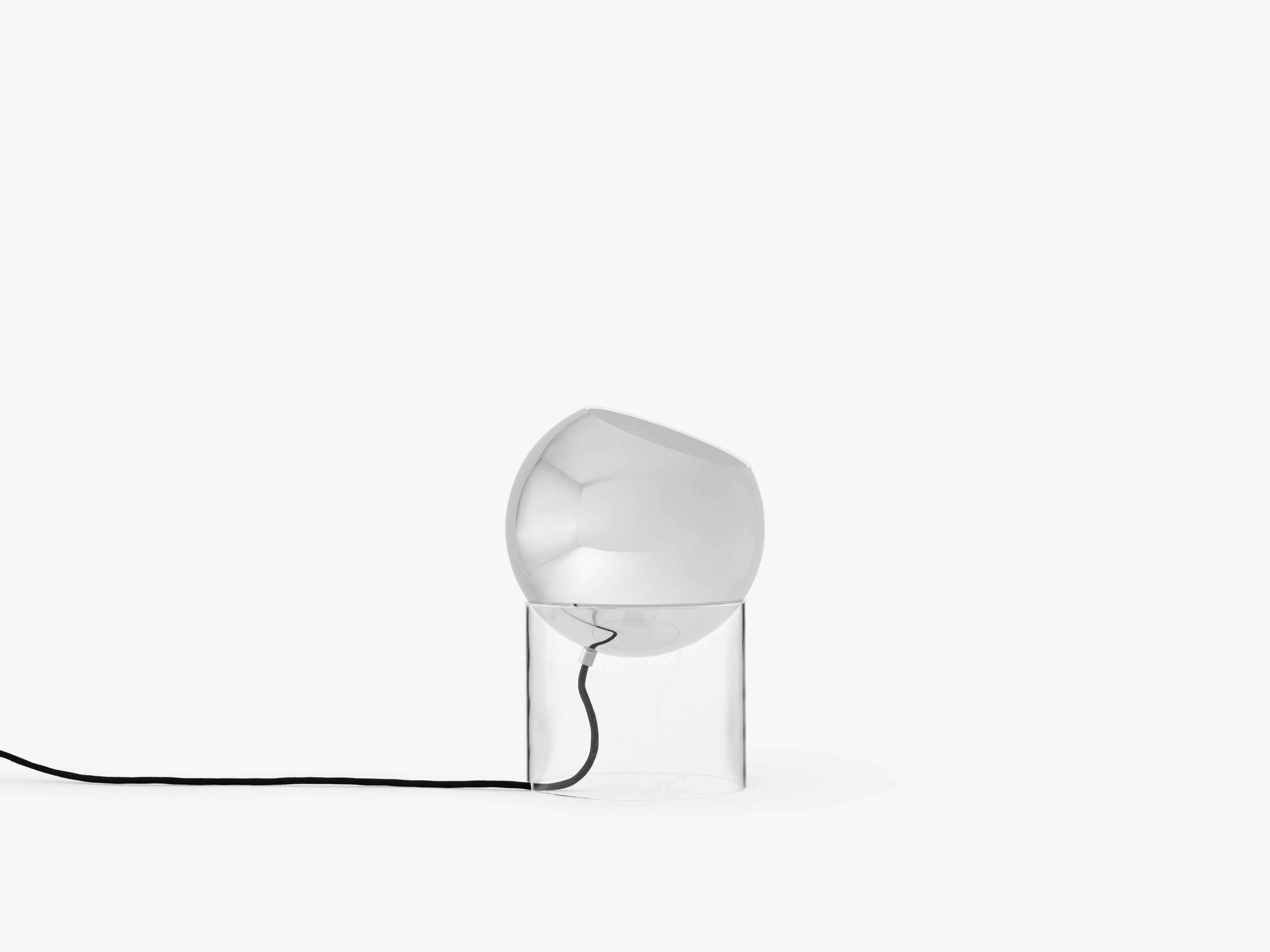 TOPAN VP13 table lamp with a chrome shade and transparent base.