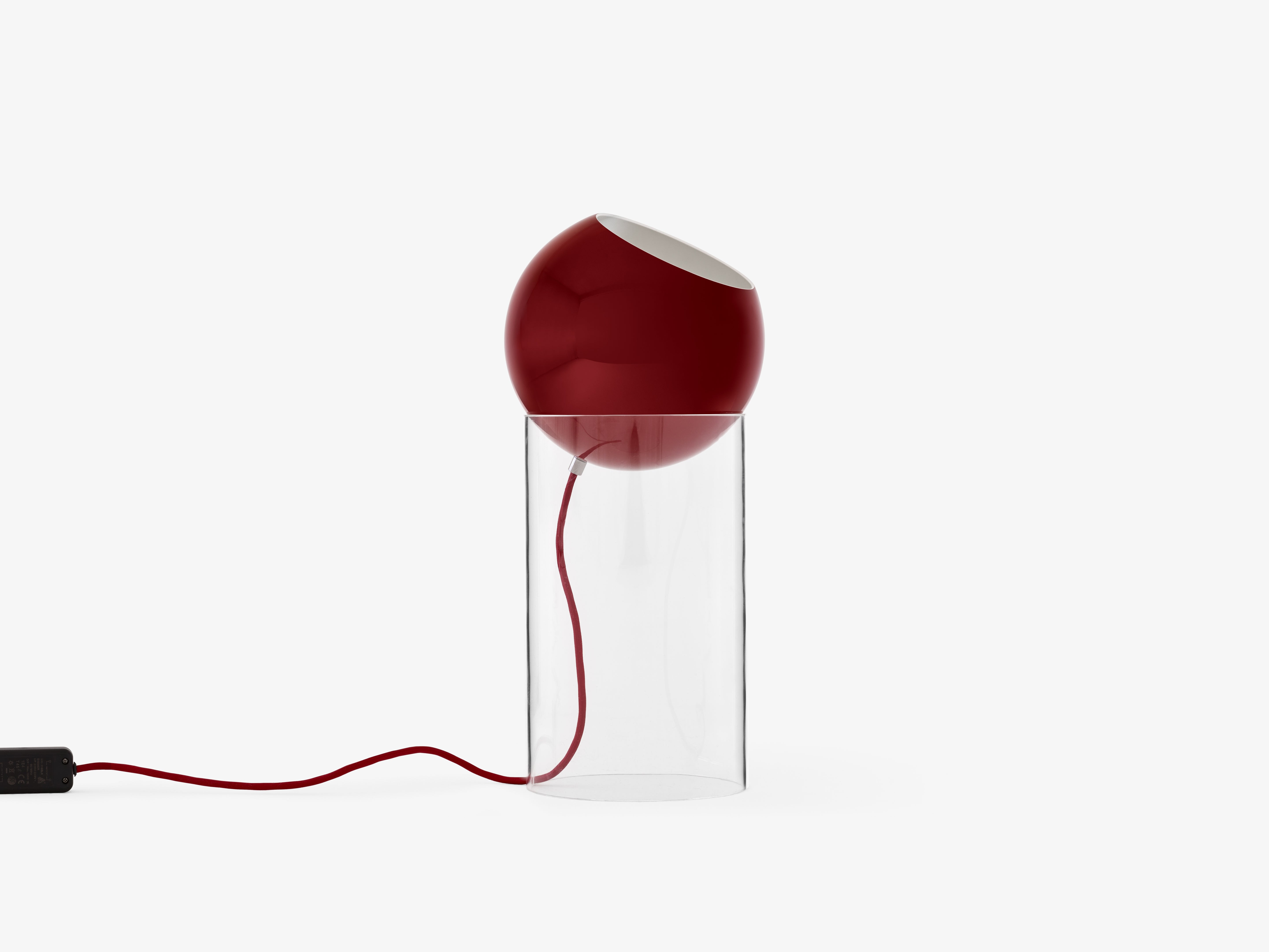 TOPAN table lamp with a red shade and transparent base.