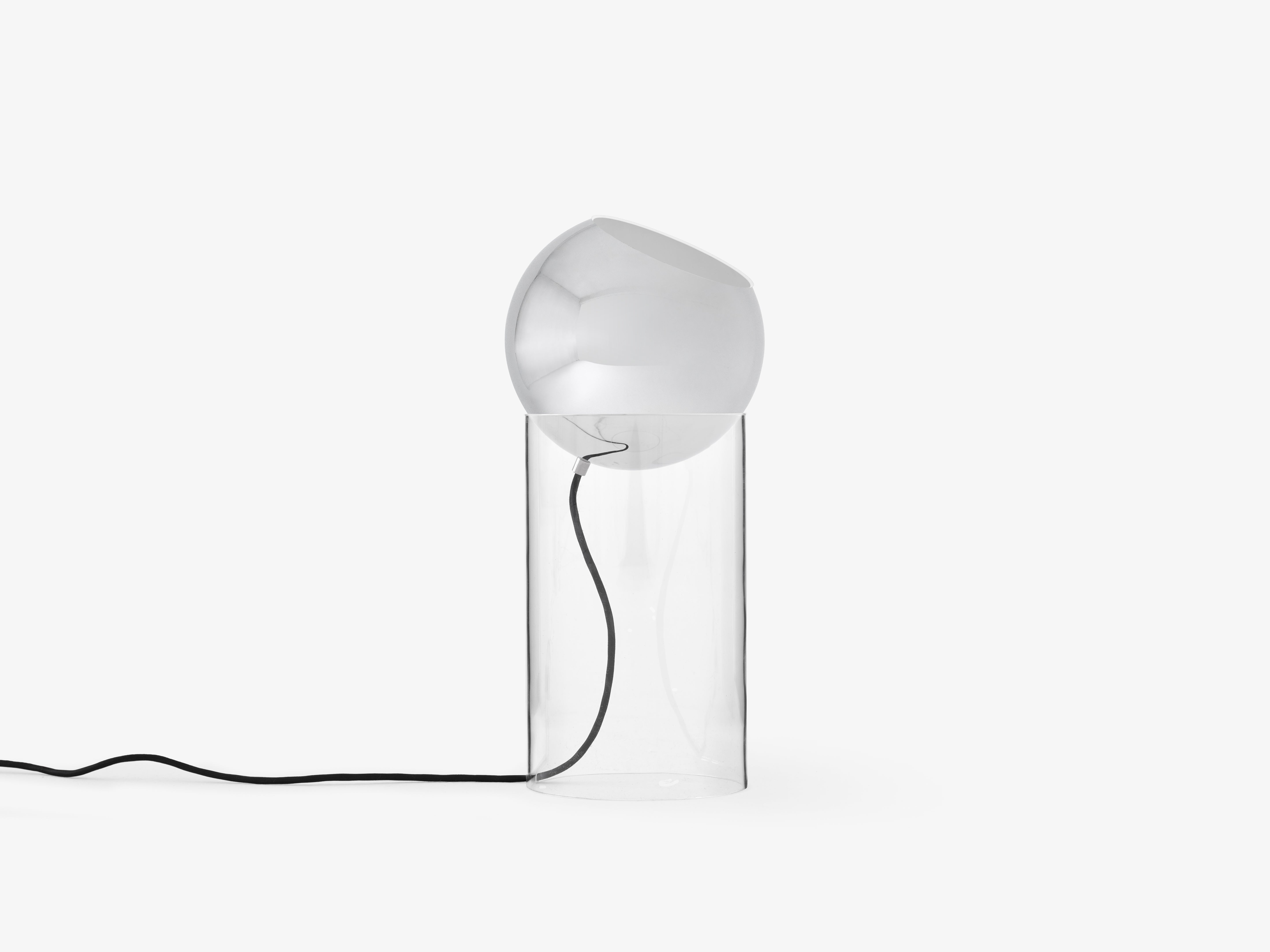 TOPAN table lamp with a chrome shade and transparent base.