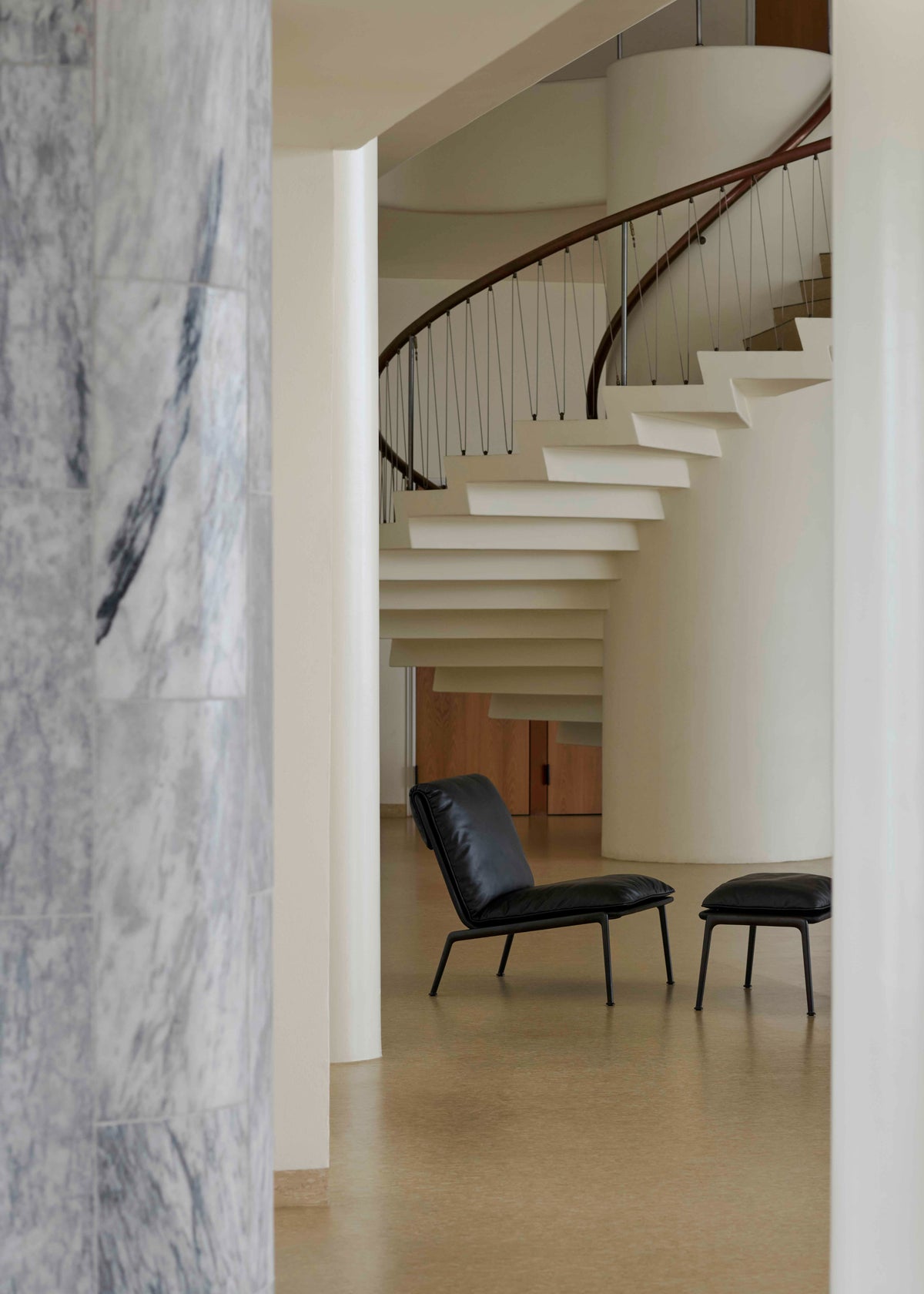 MUNO LN18 upholstered armchair with a black base