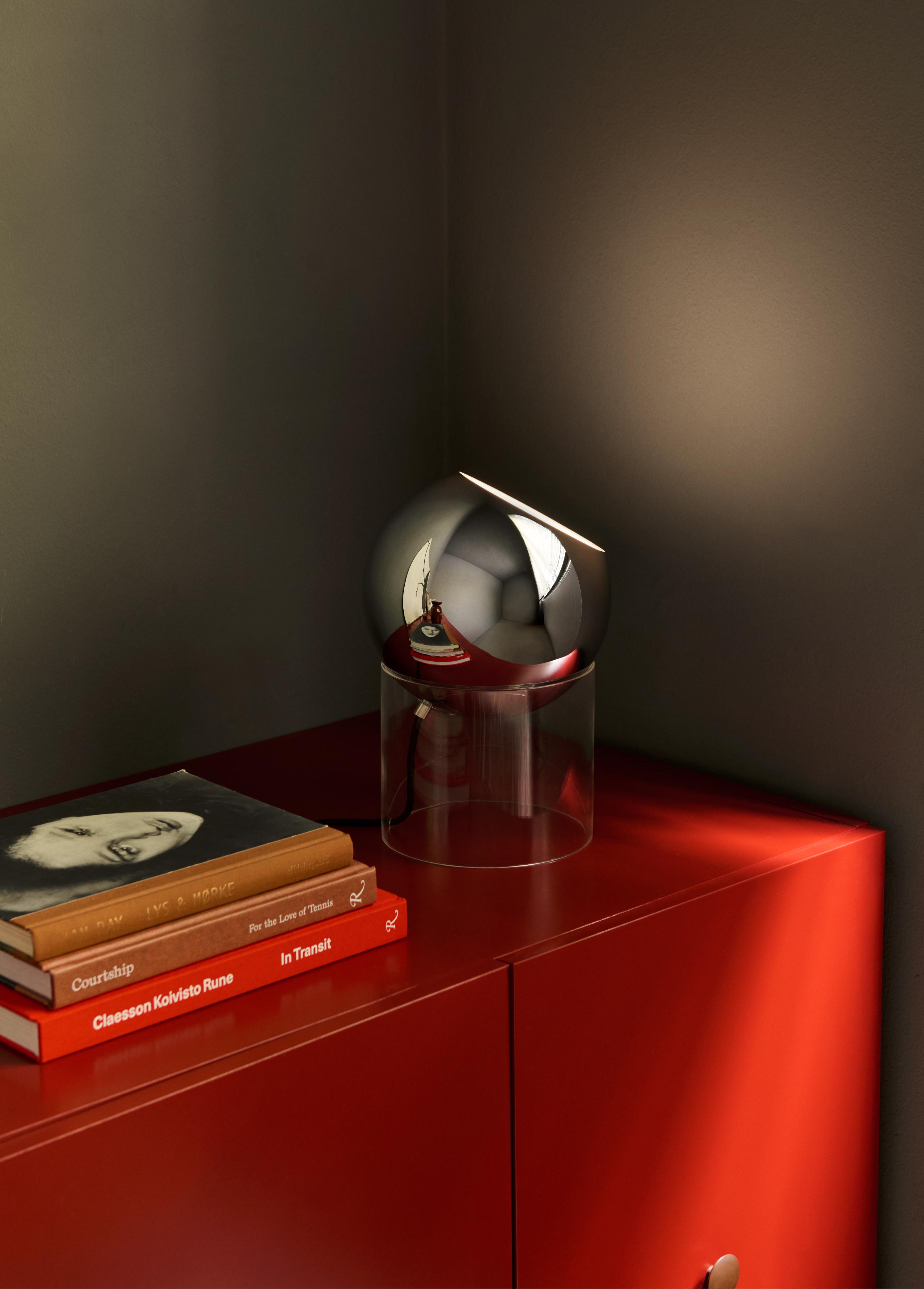 TOPAN VP13 table lamp with a chrome shade and transparent base.