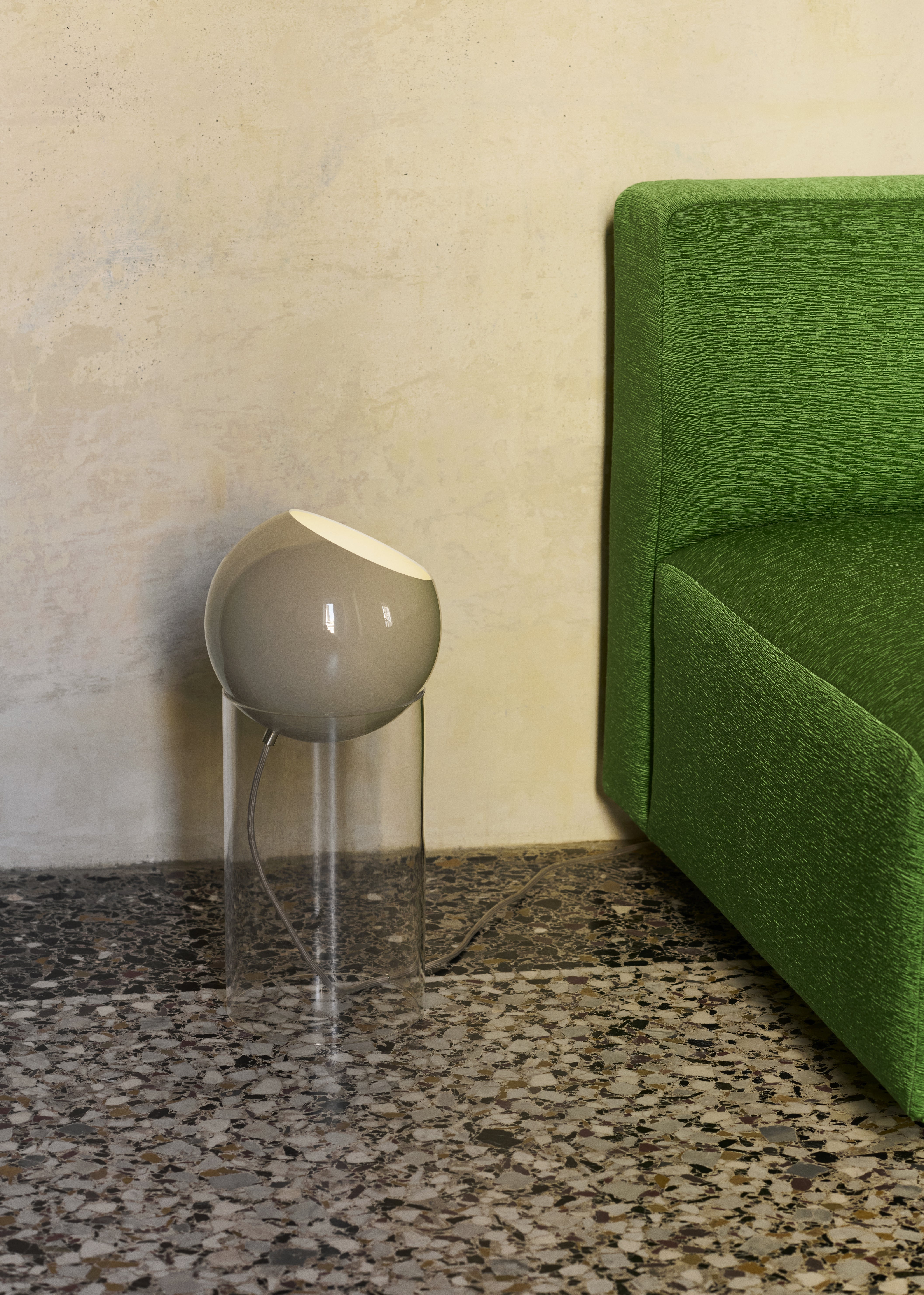 TOPAN table lamp with a gray-beige shade and a transparent base.