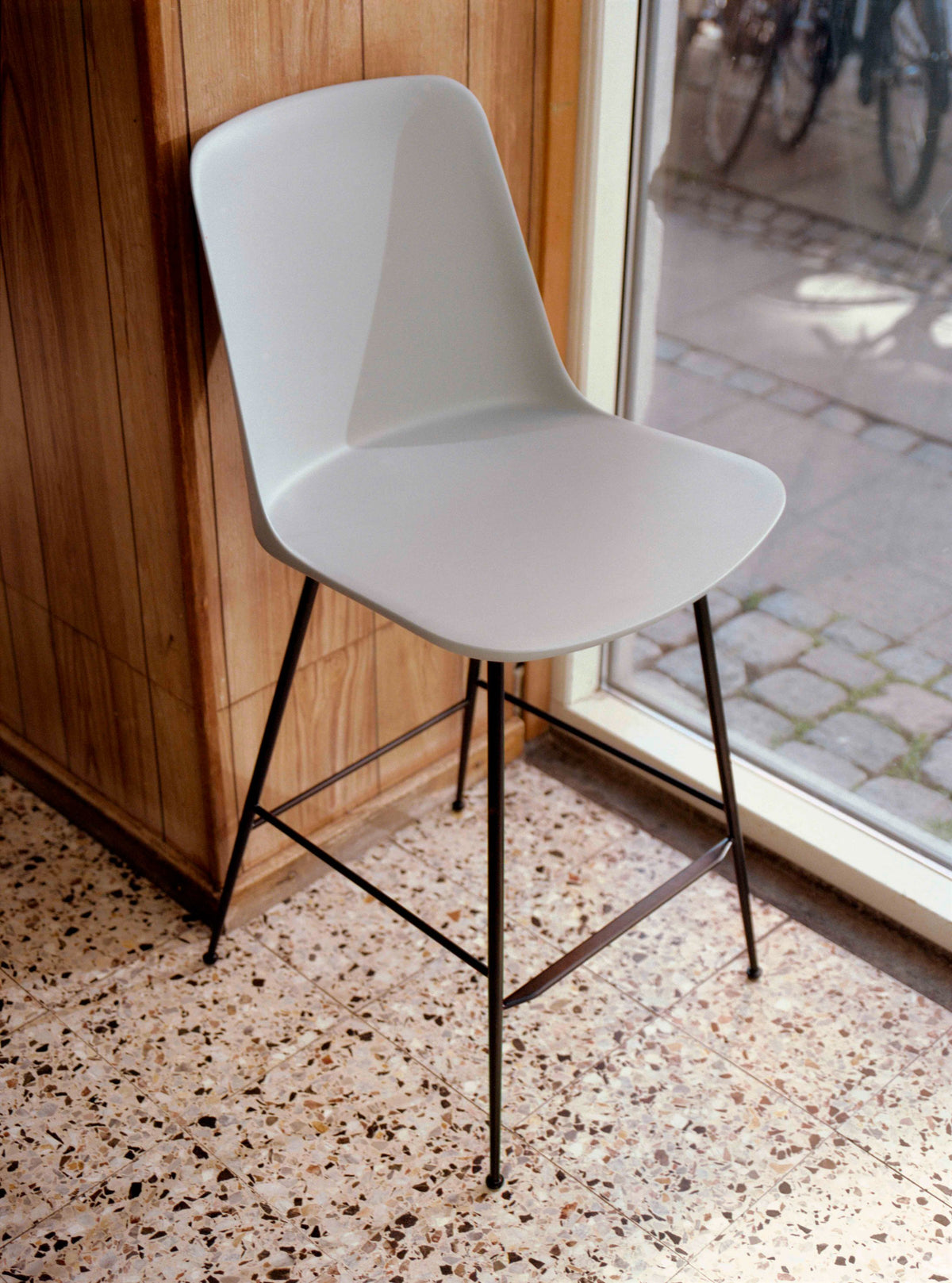 RELY bar stool in white with a brown steel base