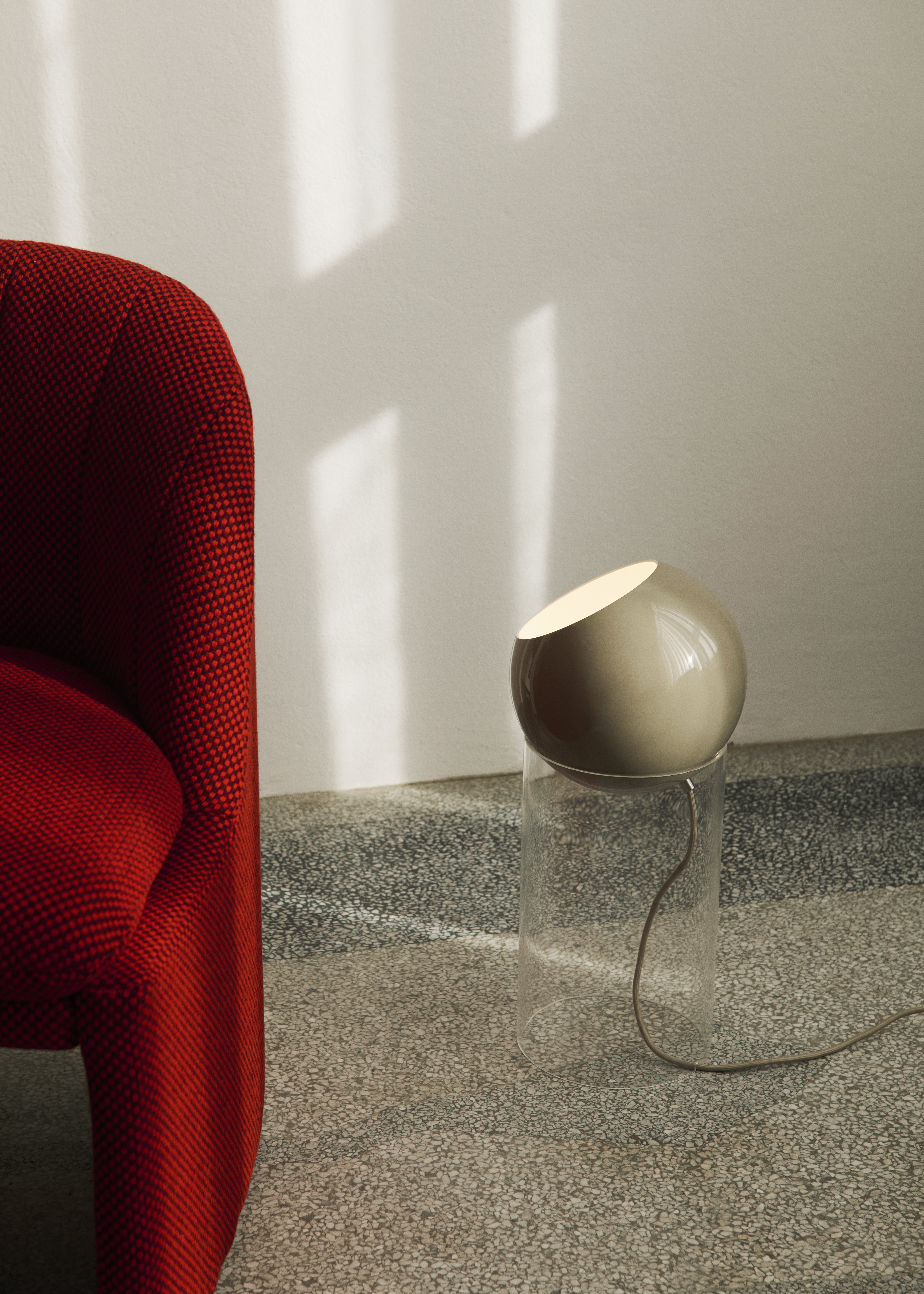 TOPAN table lamp with a gray-beige shade and a transparent base.