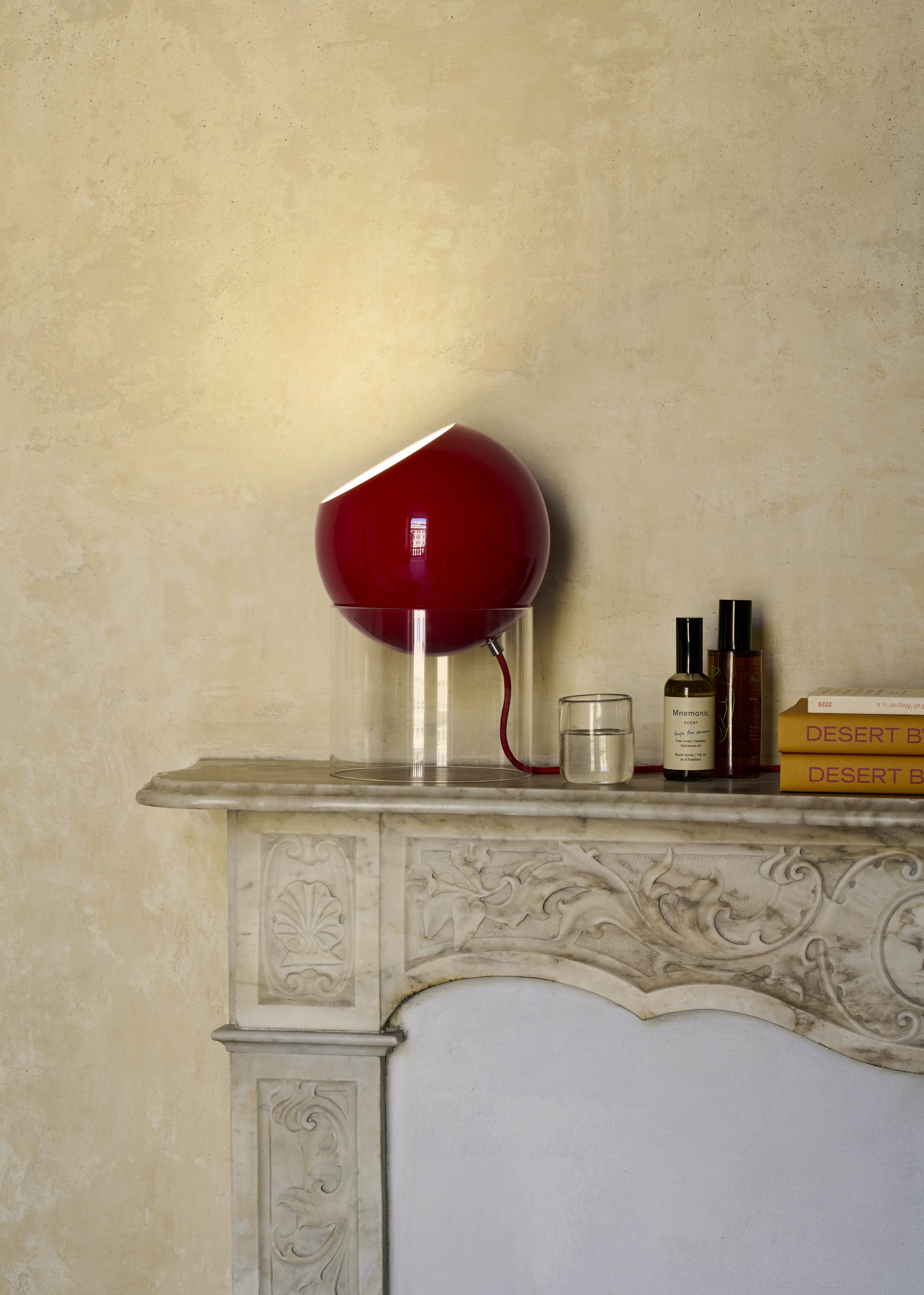 TOPAN table lamp with a red shade and transparent base.