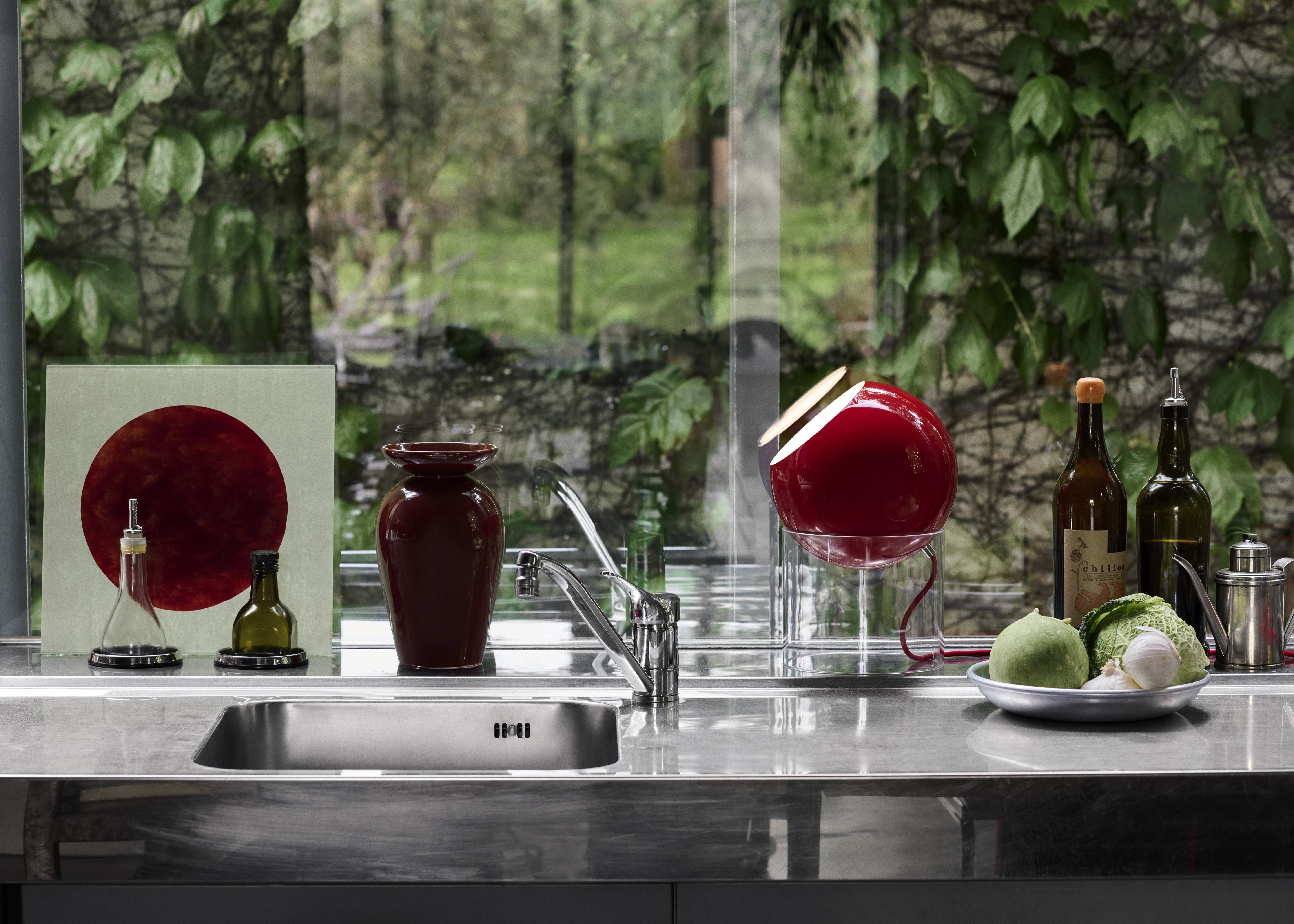 TOPAN table lamp with a red shade and transparent base.