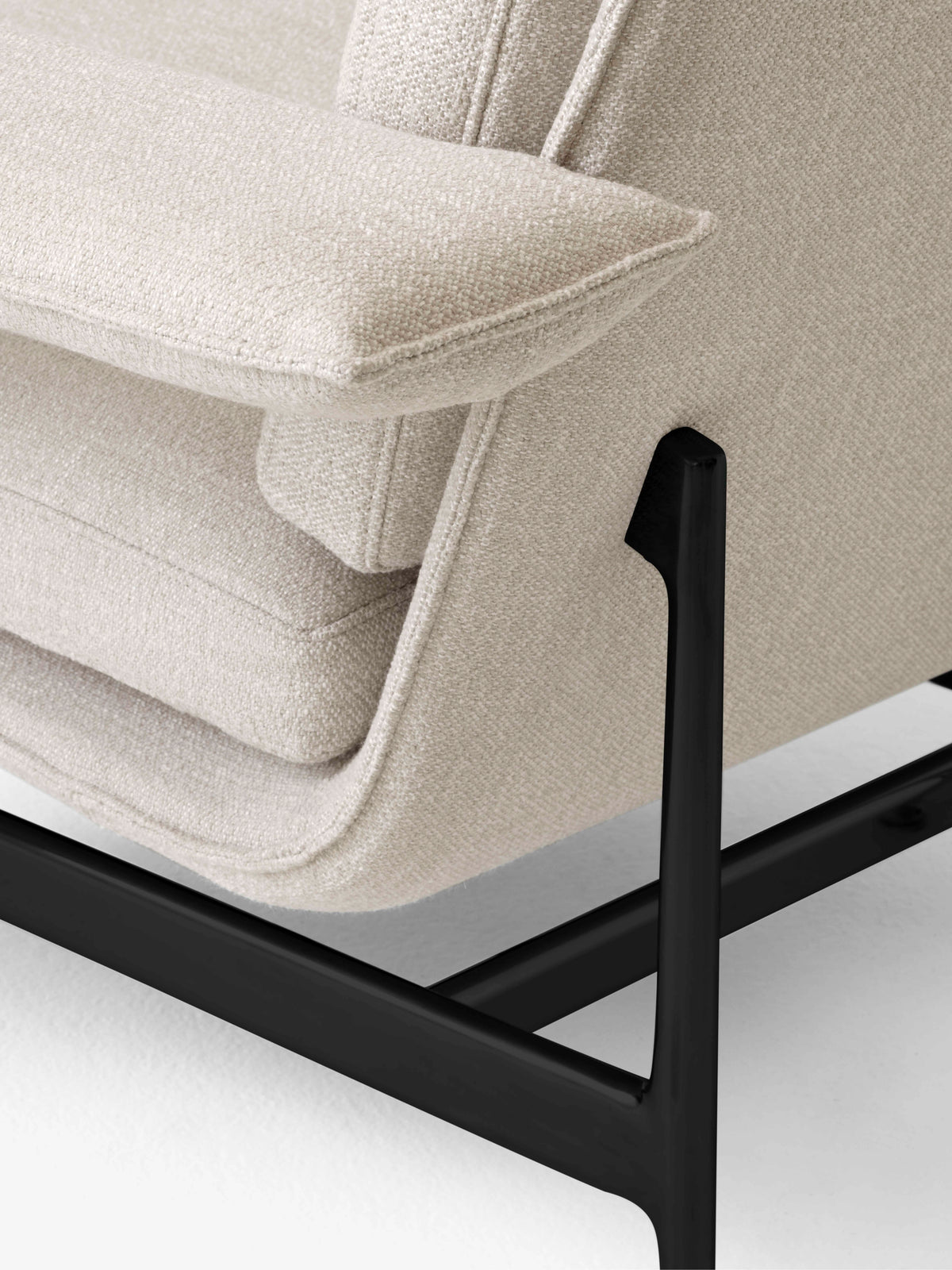 MEANTIME AV29 upholstered armchair with a black base
