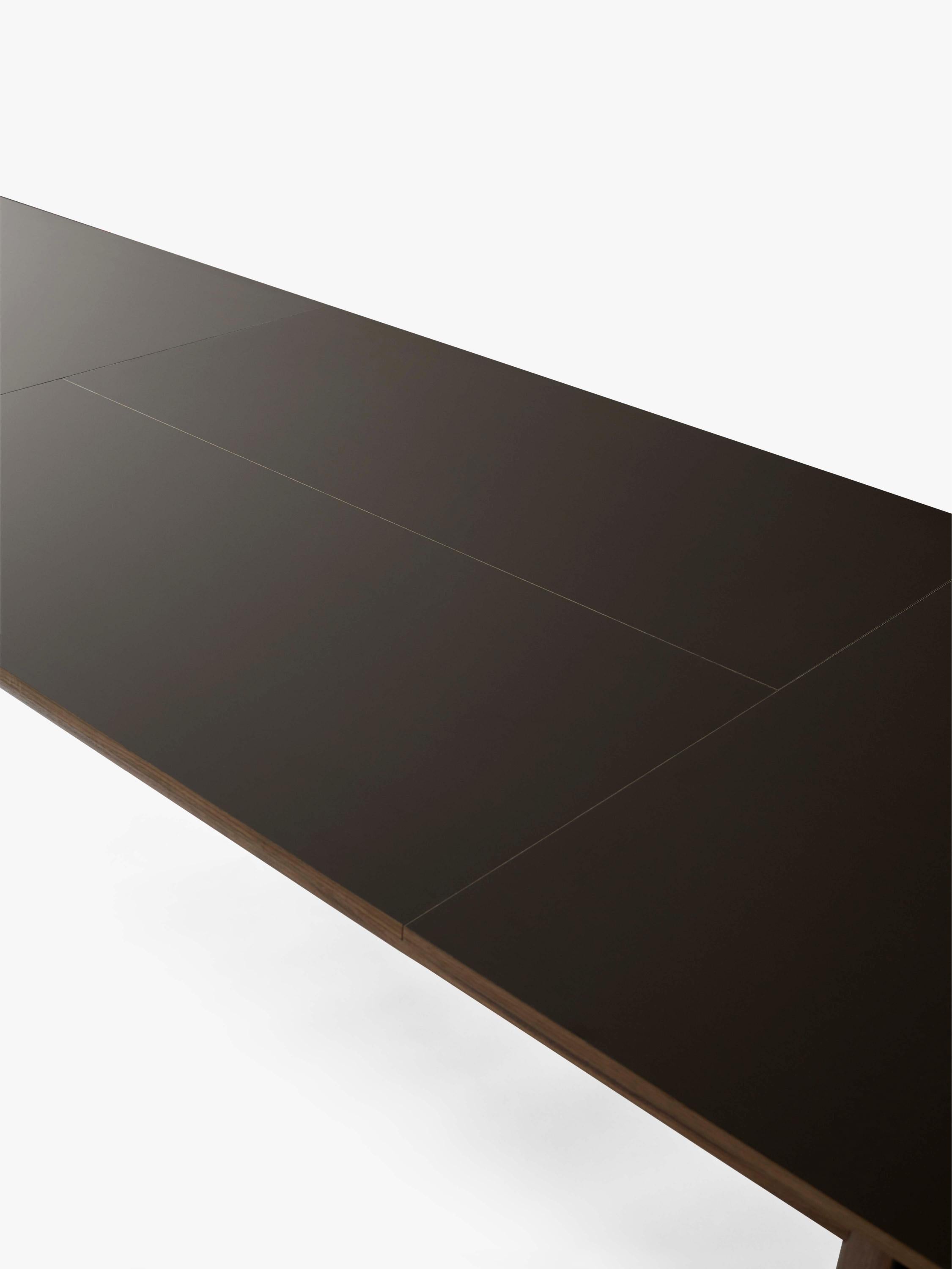 PATCH extendable table with a brown laminated top and walnut base