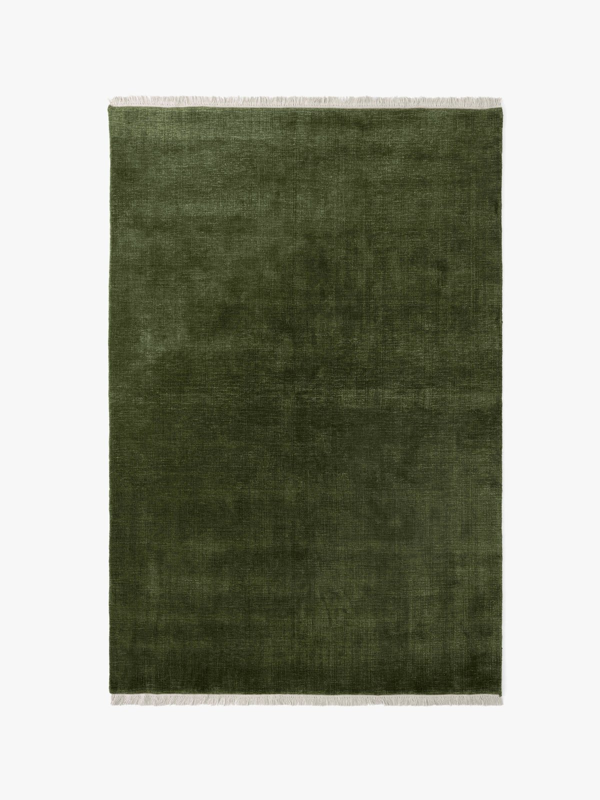 THE MOOR fringed rug in dark green