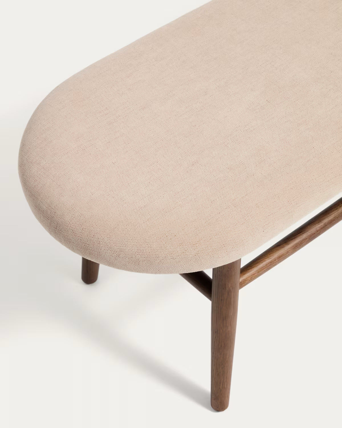 HELD bench in beige chenille with a dark veneered oak base.